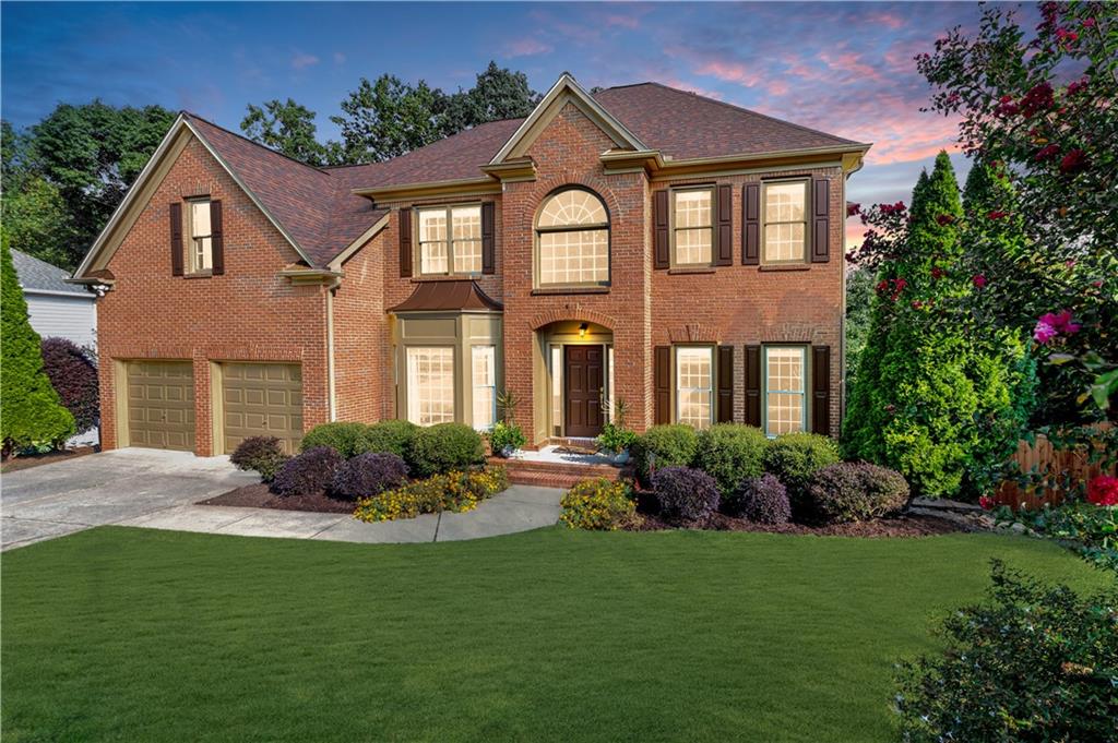 Come HOME to this 5-Bedroom, 4-Bath, Brick-front Beauty! Located in Morningview in the heart of Suwanee, one of Georgia’s most desirable cities, this home offers the perfect blend of space, style, and community living. Step inside the grand two-story foyer with hardwood floors throughout the main level and enjoy elegant formal spaces including a separate dining room and living room/office alongside an open-concept design ideal for today’s lifestyle. The kitchen is a chef’s delight with solid surface countertops, new stainless-steel appliances, a center island, and custom walk-in pantry— flowing seamlessly into the sunny breakfast nook and fireside family room, where soaring ceilings and floor-to-ceiling windows showcase stunning wooded views. Just off the kitchen, step onto the deck to enjoy a private retreat that borders Suwanee Creek— offering a serene escape surrounded by natural beauty, wildlife, and songbirds. A beautifully designed bedroom and half bathroom complete the main level. Upstairs, retreat to the oversized primary suite featuring a tray ceiling, dual custom walk-in closets, and a newly renovated spa-like bath with an elegant centerpiece free-standing tub, beautifully tiled oversized glass shower, and double vanities. Secondary bedrooms are equally spacious, with private and shared bath options designed for comfort and convenience. The unfinished basement, stubbed for bathroom, offers incredible potential for future expansion, while the leveled, lush green backyard space offers the perfect setting for entertaining, playing, or soaking in the peaceful natural beauty. Living in Morningview means more than just a home—you’ll enjoy resort-style amenities including multiple pools (junior Olympic with water slide, splash pad, and quiet pool), tennis and pickleball courts, sand volleyball, playgrounds, clubhouse, trails to Ivy Creek Greenway and George Pierce Park, community green spaces, sidewalk-lined streets, and a calendar full of neighborhood events. Minutes from Suwanee Town Center, the Mall of Georgia, I-85, and zoned for the award-winning North Gwinnett school district – including Suwanee Elementary, North Gwinnett Middle, and North Gwinnett High School. This move-in ready gem truly has it all. Welcome Home!
