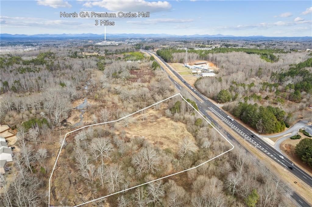 Excellent Industrial zoned (M1) property in North Forsyth County. 4 miles south of the Dawson County line in an area experiencing tremendous growth. Highway GA 400 (US 19 South) site SW of Jotem Down Road with over 800' of road frontage and access to both North bound and South bound lanes of GA 400 with a deceleration lane and median cut on the East side of GA 400. Just North of the Don Jackson Jeep Dealership and the Caterpillar Dealership. Approximately 4 miles south of the North Georgia Premium Outlet Mall.
