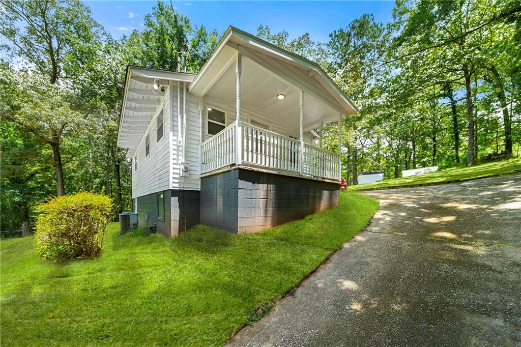 Discover the perfect blend of modern luxury and serene nature in this beautifully updated home situated on 0.78 acres, directly across from Sweet Water Creek State Park. This exquisite property features a brand new well pump and well house, ensuring reliable water supply. Enjoy the convenience of an existing easement for a secondary driveway, providing easy access from the other end of the property line.
Step inside to find a stunningly modernized interior, complete with high-end finishes throughout. The main-level master bedroom offers direct access to a spacious back deck, a walk-in closet, and new doors and windows that flood the space with natural light. The lower level boasts elegant tiling, adding to the home's charm. Recent upgrades include new drywall, flooring, appliances, HVAC, and a roof, ensuring a move-in ready experience.
The outdoor space is equally impressive, featuring a covered front porch, a workshop/outbuilding equipped with electricity, convenient hookups for RVs with both power and water readily available, and a concrete pad ideal for enjoying the full property—perfect for outdoor furniture or a gazebo. Additionally, a new septic tank has been fully replaced, with receipts available for peace of mind.
This meticulously maintained property is a rare find, offering both privacy and proximity to nature's beauty. Don't miss your chance to make this exceptional home yours! *Photography will be uploaded on 7/14/25*