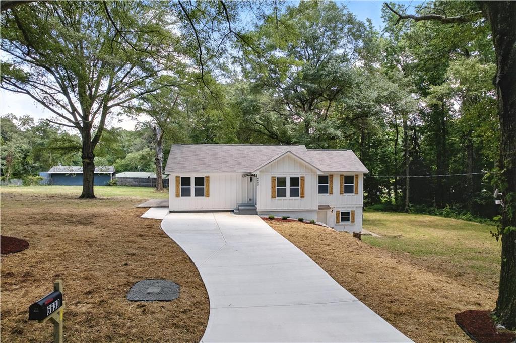 Welcome to Your Dream Home at 6630 Lucile Ave
From the moment you turn onto the quiet, tree-lined street of Lucile Avenue, a sense of peace welcomes you home. Nestled among towering trees and resting on a spacious lot, this fully renovated modern farmhouse is more than a house — it’s a feeling.
As you step up the wide, welcoming front steps, you can already imagine sipping morning coffee on the porch while the Georgia sun filters through the leaves above. Open the front door, and you’re greeted by an open-concept layout flooded with natural light, stylish finishes, and thoughtful details that balance elegance with comfort.
The heart of the home — the gourmet kitchen — will leave you breathless. Featuring a statement waterfall island with warm wood accents, sleek quartz counters, modern pendant lighting, and white shaker cabinets, this space is built for both functionality and style. Whether it’s breakfast with the kids or hosting wine nights with friends, this kitchen adapts to your lifestyle beautifully.
Flow effortlessly into the cozy living space, where warm-toned LVP flooring runs underfoot, and every element is designed to invite connection, conversation, and calm.
The bathrooms are spa-worthy — decked in stunning marble-style tile, matte black fixtures, and double vanities that blend form with function. Each bedroom offers a retreat-like escape, with natural views, modern finishes, and ample closet space. The split-bedroom layout offers privacy for guests or family members, while the finished basement opens up endless possibilities — home office, game room, or even an in-law suite.
Step outside and feel the magic of this private, wooded lot. There's room to garden, entertain, or just breathe in the fresh air. And with a long, curved driveway, there’s space for guests to visit and stay a while.
Living in Lithia Springs means more than just owning a beautiful home. You're minutes from Sweetwater Creek State Park, where weekends are for hiking, kayaking, or picnicking by the water. Enjoy local breweries, quaint shops, and charming eateries just a short drive away. Downtown Atlanta is close enough for a quick commute, yet far enough to keep your evenings quiet and peaceful.
This isn’t just a home — it’s the life you’ve been searching for.