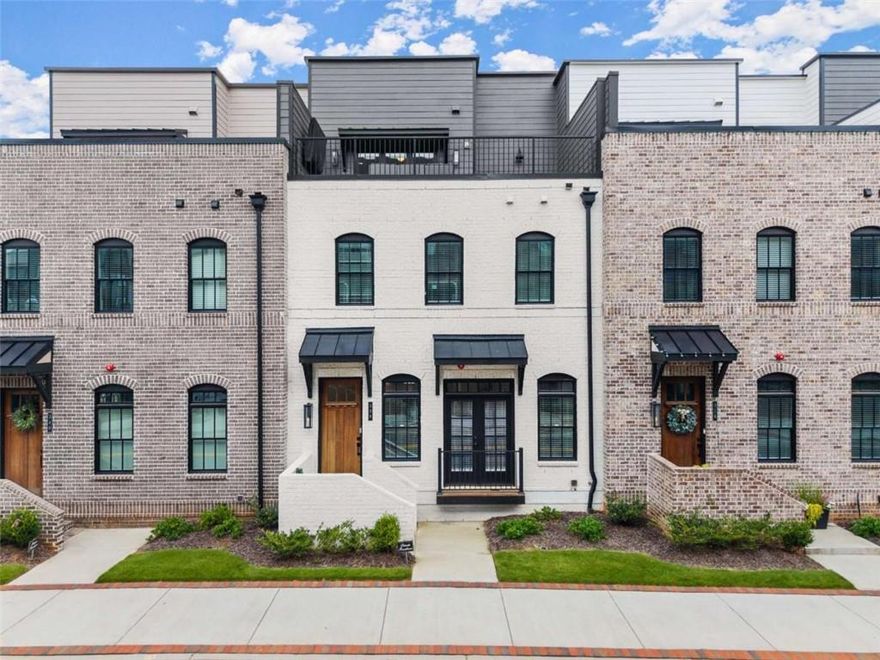 Is there a 4-bed townhome in Downtown Sugar Hill with a rooftop terrace and lease-to-own flexibility? Yes and it just dropped $75K. This four-story luxury townhome is packed with value, style, and walkability just steps from The Bowl, Eagle Theatre, and the Sugar Hill Greenway.

Lease-to-purchase opportunity available move in now, buy later! Ideal for buyers building credit, preparing for financing, or needing flexibility. Now priced $75,000 below market, this townhome offers premium finishes and modern convenience in a location that puts you in the heart of Sugar Hill’s best amenities.

The open main level features designer lighting, luxury flooring, and a gourmet kitchen with quartz countertops, stainless appliances, custom cabinetry, and a spacious island that opens to a covered balcony. Upstairs, the owner’s suite includes a frameless glass shower, dual vanities, and custom closet system. Every bedroom includes a private bath for maximum privacy.

A flexible bonus room with sliding doors opens to a turf-covered balcony perfect as a home office, playroom, or media space. The entry level includes a private guest suite with full bath, ideal for visitors or in-laws. A private elevator connects all four floors.

The rooftop terrace is an entertainer’s dream: turf flooring, grilling area, covered TV mount, and panoramic city views.

Special financing available through Jeff Zulauf at Cross Country Mortgage with a 2-1 Rate Buydown starting as low as 4.125% in Year 1 (restrictions apply).

Call or text Cindy LaDuke at 678-650-1425 to schedule a private tour or ask about lease-to-purchase terms.