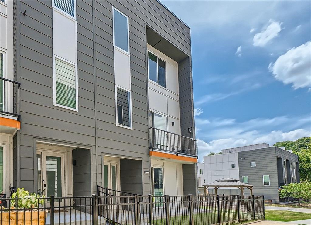 Welcome to urban living at its finest in this contemporary modern townhome, ideally situated in the heart of the city of Atlanta in Kirkwood only minutes from Top Rated Golf Club-East Lake Country Club, East Atlanta and near restaurants, shopping, parks, and subways. This stunning residence is just 4 years young, offering a perfect blend of style, convenience, and functionality. As you enter, you're greeted by a fence front yard with artificial turf, ensuring a low-maintenance outdoor space ideal for relaxation or gatherings. The highlight of this home is the expansive rooftop terrace, providing ample space for outdoor dining, entertaining, and enjoying city views. Inside, the interior is adorned in chic white tones and boasts an open floor plan that enhances the sense of space and light. The large open kitchen features a generous quartz island, complemented by stainless steel appliances, making it a chef's dream. Adjacent to the kitchen, the spacious living room is perfect for both everyday living and hosting guests with its contemporary design. The primary suite is a true retreat, offering two custom closets and a luxurious marble bathroom complete with a large shower and quartz double vanity. Each secondary bedroom also enjoys the luxury of its own full bath, providing privacy and comfort for all residents and guests. Additional highlights include a deep rear-facing two-car garage, designed to accommodate even the largest vehicles, ensuring both convenience and security. Community has a small Dog/Pet Park! This home is better than new, meticulously maintained and upgraded, and located in an excellent neighborhood that offers the best of urban living and a modern lifestyle.  Sellers offer a one-year home Warranty! It's all here! Hurry!