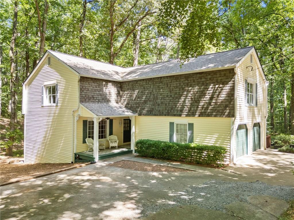 Charming Cottage on Nearly 4 Private Acres in Sought-After Cherokee County School District
Full of character and nestled in a peaceful, wooded setting, this enchanting 4-bedroom, 3.5-bath cottage-style home is situated on almost 4 private acres in one of Cherokee County’s most desirable school districts. A circular driveway leads to the classic rocking chair front porch, setting the tone for the charm and comfort that awaits inside.
The main level features a welcoming foyer, formal living and dining rooms, a cozy country kitchen, and a spacious great room filled with natural light—perfect for everyday living and entertaining. A combined laundry/mudroom conveniently connects to the oversized two-car garage for added functionality.
Upstairs, the primary suite offers his-and-her walk-in closets and a private bath. Two additional bedrooms each feature large walk-in closets and share a well-appointed hall bath. A dedicated hobby room with built-in storage and an oversized bonus room over the garage (ideal for a playroom, media room, or potential 5th bedroom) provide flexible space to fit your needs.
The terrace level adds even more living space, complete with a large great room, private office, full bath, and a spacious bedroom with three closets—ideal for guests, teens, or multigenerational living.
Enjoy the outdoors on the expansive wraparound deck, perfect for entertaining or relaxing while taking in the tranquil, private backyard. The property also includes an older greenhouse outbuilding, full of potential for restoration and creative use.
Offering timeless charm, a versatile floor plan, and a serene setting in a top-rated school district, this one-of-a-kind property is ready to welcome you home.