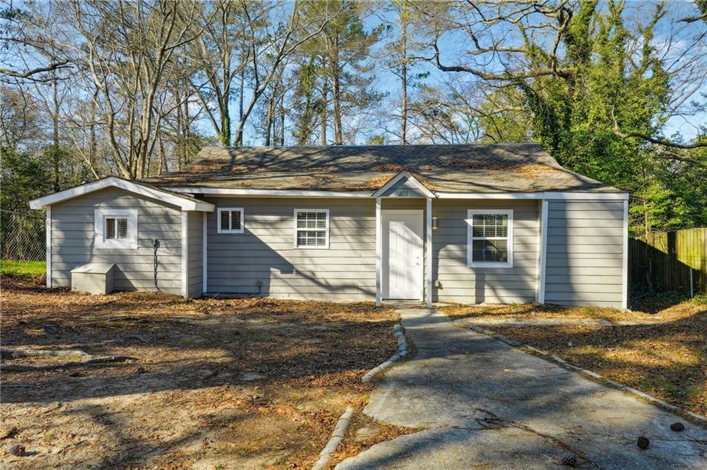 Discover a peaceful retreat in the heart of Atlanta. Perched on an elevated slope and surrounded by lush greenery, this home offers a rare sense of privacy while keeping you close to all the city's conveniences. Inside, you'll find three spacious bedrooms and two bathrooms, thoughtfully updated for style and comfort. The kitchen features stainless steel appliances, new granite countertops, a custom backsplash, and plenty of cabinet space. Throughout the home, luxury vinyl plank flooring and high-end light fixtures create a fresh, modern feel. Whether you're relaxing in the open living area or enjoying the serene surroundings outside, this home blends comfort, convenience, and charm.
