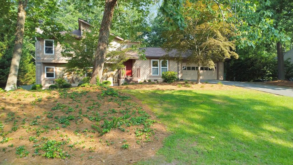 Look no further because this is the one! Welcome to this charming and well-maintained 4 bed / 3 bath split-level home in a prime East Cobb location, just minutes from the interstate and situated in the sought-after Wheeler High School district. Step inside to a bright and inviting living room featuring vaulted ceilings and a skylight that fills the space with natural light. Just a few steps down, the fireside family room offers the perfect setting for relaxing or entertaining with friends and family. The elegant kitchen is equipped with stainless steel appliances, white cabinetry, granite countertops, and a cozy breakfast area - ideal for casual meals and morning coffee. Upstairs, the primary suite offers his and hers closets and a private en suite bath. Two additional bedrooms share a hall bath on the upper level, while the lower level includes a fourth bedroom, full bath, and laundry room. The expansive back deck overlooks a private backyard with a large flagstone patio, offering plenty of space for relaxing or entertaining. Don’t miss this fantastic opportunity to own a beautiful home in one of East Cobb’s most convenient locations!