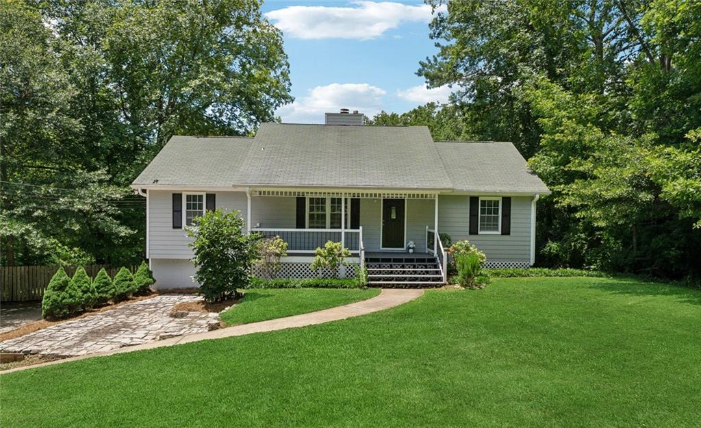 Welcome to your slice of heaven, just 1 mile from Downtown Ball Ground! This lot features over an acre of private, level yard with multiple decks and a sunroom/playroom. A detached shed/garage provides additional storage. The home is located in a cul-de-sac and includes a covered front porch. Step into the living room with a stone gas fireplace. The kitchen offers painted white cabinets and stainless steel appliances, all of which remain with the home. This split-bedroom plan has no carpet—laminate flooring runs throughout. Ceiling fans are in all bedrooms. Enjoy newer garage doors leading to a spacious garage and an unfinished area, ready to be converted into an additional bedroom and bathroom.