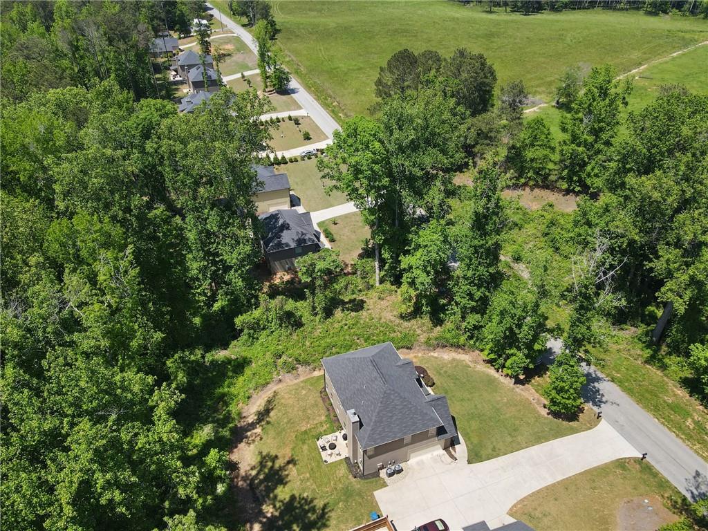 Come see this beautifully maintained 4-bedroom, 2.5-bath home sits on a spacious and level 0.8-acre lot, just minutes from the vibrant and growing downtown Auburn. Built in 2019, the home features fresh interior paint throughout and brand-new flooring on the main level, completely move-in ready.
The heart of the home is the open-concept kitchen, complete with granite countertops, a large island, stained cabinetry, stainless steel appliances, and a generous walk-in pantry. It flows seamlessly into the living room, where a cozy fireplace makes for the perfect gathering spot. Upstairs, you'll find four generously sized bedrooms, including a luxurious primary suite with tray ceilings, a sitting area, and a spa-like bathroom featuring a soaking tub, separate shower, and dual vanity. Laundry is conveniently located upstairs as well, along with three additional bedrooms, each offering ample closet space. Close to everything you could need-shopping, dining and easy access to highways.