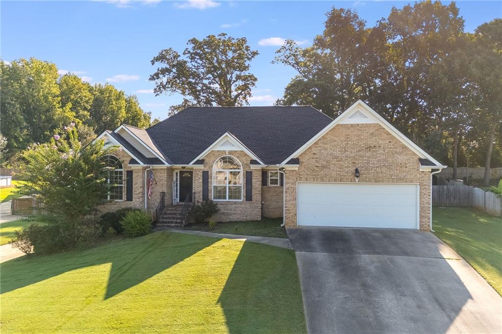 Tucked into the sought-after charm of South Paulding County, this brick front ranch feels like it was designed for both the peaceful moments and the big life chapters still to come. Mornings here start in the vaulted family room, where sunlight spills across the hardwood floors and the gas log fireplace promises cozy evenings ahead.
The kitchen’s tiled floor stays cool underfoot as you brew coffee, while the sliding barn door to the dining room hints at both style and warmth—ready to welcome friends for a lingering dinner or host holiday feasts.
Beyond the main floor, a full, unfinished basement awaits—a blank canvas with its own driveway and exterior entry. Will it be a guest suite? A workshop? A game room? The choice is yours, and the space is ready when you are.
The primary suite offers a private retreat, complete with double sinks, a soaking tub, and a separate shower—perfect for unwinding at the end of the day. Outside, the screened back porch looks out over the fully fenced yard, where loved ones and pets can play freely and chilly fall nights invite laughter under the stars.
With two driveways, no HOA, and a location that makes Villa Rica, Hiram, Dallas, and Douglasville all an easy drive, this is more than a house—it’s the start of your next chapter.