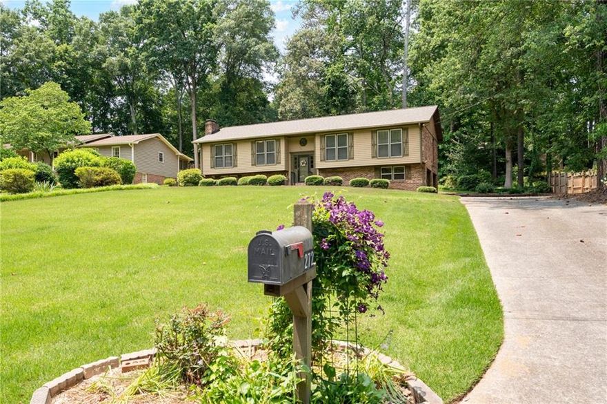 Blending vintage character with tasteful updates, this mid century style home is located in a quiet, established neighborhood where homes are rarely available for sale. Whether you are a retro enthusiast, savvy investor or creative remodeler, this home offers endless potential and unique features that are just not found in newer builds. If you appreciate the quality of 4 sided brick with cedar siding, a brand new 30 year architectural roof, vintage tile, and solid wood doors and cabinets, this is the one for you! The oversized living room has a brick fireplace, original wood paneling and a vaulted ceiling; the kitchen features stained wood cabinets and stainless steel appliances, and opens directly into a sunroom addition that the previous owners used in all 4 seasons. Just imagine enjoying the backyard gardens from the comfort of the deck or sunroom, and watching the birds at the feeder with your morning coffee! The primary bedroom is large with an attached en suite bath and walk in closet. Two secondary bedrooms, a hall bath and a dining room finish off the first floor. Downstairs is a finished flex room with a second fireplace that could be a movie room, 4th bedroom, playroom, teen hangout  or home gym. The oversize garage offers plenty of storage as it runs the full length of the back of the house. The yard is professionally landscaped and planted with many perennials that will return year after year to surprise and delight. The street ends in a cul de sac just one house away. No HOA! Minutes from Dallas Highway and the Avenues of West Cobb, and close to hiking trails, restaurants, the East West Connector and Marietta Square. Per Seller request, no blind offers please.