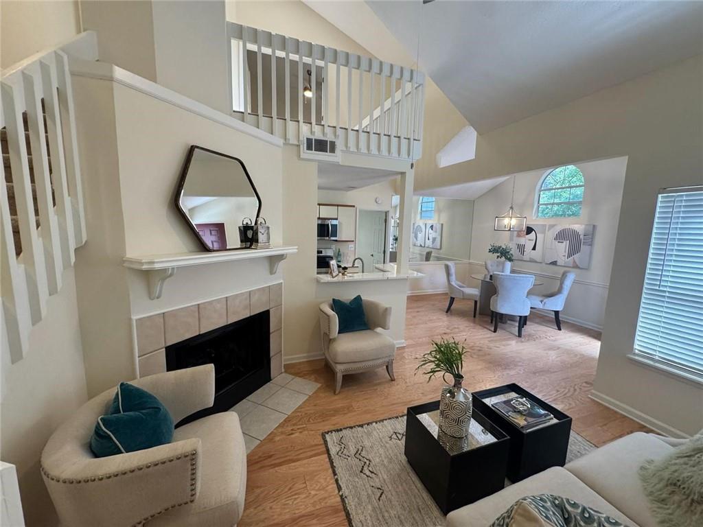Beautifully renovated top-floor, end-unit condominium filled with natural light and located in a peaceful, wooded community near the Chattahoochee River and a 27-acre park. This spacious 2-bedroom, 2-bath with a bonus loft space, ideal for a home office featuring an open floor plan with soaring vaulted ceilings, skylight, and wood-burning fireplace. The main level boasts new hardwood floors, modern lighting, and updated hardware throughout. The kitchen is fully upgraded with quartz countertops, stained cabinetry, tile backsplash, and all new stainless steel appliances. A separate formal dining room and a light-filled breakfast area offer multiple options for entertaining. The primary suite features a vaulted ceiling, walk-in closet, and en-suite bath with a tub/shower combo. All bedrooms offer vaulted ceilings and walk-in closets. Enjoy the golf course view from the front porch, plus assigned parking and plenty of guest parking. The entire community is undergoing exterior upgrades with new cement siding. Residents also enjoy access to amenities including a pool, tennis courts, and over 20 acres of parkland with walking trails along the river. Conveniently located near shopping, dining, Historic Downtown Roswell, Alpharetta, Avalon, and The Forum.