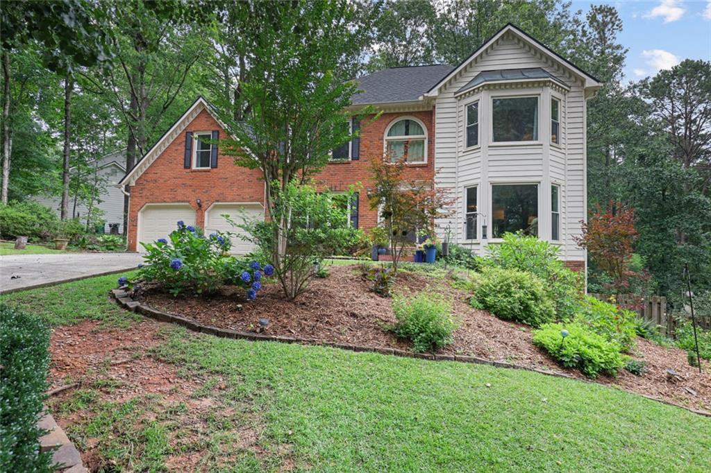 Exceptional Opportunity in Prime East Cobb Location!
Welcome to this charming 4-bedroom, 2.5-bathroom traditional home, located in the highly sought-after Timber Ridge/Dodgen Middle/Walton High School district. Offering an extraordinary living experience, this home is perfect for those seeking comfort, style, and a serene connection with nature.
As you arrive, you’re greeted by outstanding curb appeal, with a beautifully landscaped front yard - a true gardener’s paradise. The almost one-acre lot is filled with vibrant hydrangeas, Japanese maples, hostas, and peonies, setting the stage for the inviting beauty that awaits inside.
Enter through a beautifully crafted, carved front door into a freshly painted interior. The sun-filled sitting room, with a stunning round window overlooking the lush front garden, welcomes you with warmth and character.
Flow effortlessly into the spacious living room, where a cozy fireplace, a wet bar with built-in shelving, and ample space make it ideal for both entertaining and relaxing. Hardwood floors throughout the main level add to the home’s timeless charm.
The updated kitchen is a chef’s delight, featuring stainless steel appliances, butcher block countertops, a stylish tile backsplash, and a walk-in pantry. A breakfast area bathed in natural light provides the perfect spot for casual meals, while the adjoining formal dining room is ready for hosting memorable gatherings.
The primary suite is a true sanctuary, offering an oversized bedroom with a cozy sitting area, a walk-in closet, and a spa-like en-suite bathroom with dual vanities and a separate vanity space. The additional bedrooms are generously sized, and the freshly cleaned carpet upstairs adds comfort and warmth.
Step out onto the spacious screened-in porch, where you’ll find breathtaking views of the private wooded backyard. This peaceful retreat backs to a creek and lush green space—a nature lover’s dream. Imagine starting your mornings with the sound of birds chirping or ending the day with the tranquil rushing of the creek below. Daily deer sightings add to the magic of this serene setting.
The side fully fenced backyard offers plenty of space for kids and pets to play, while the enclosed porch is perfect for unwinding with your favorite drink.