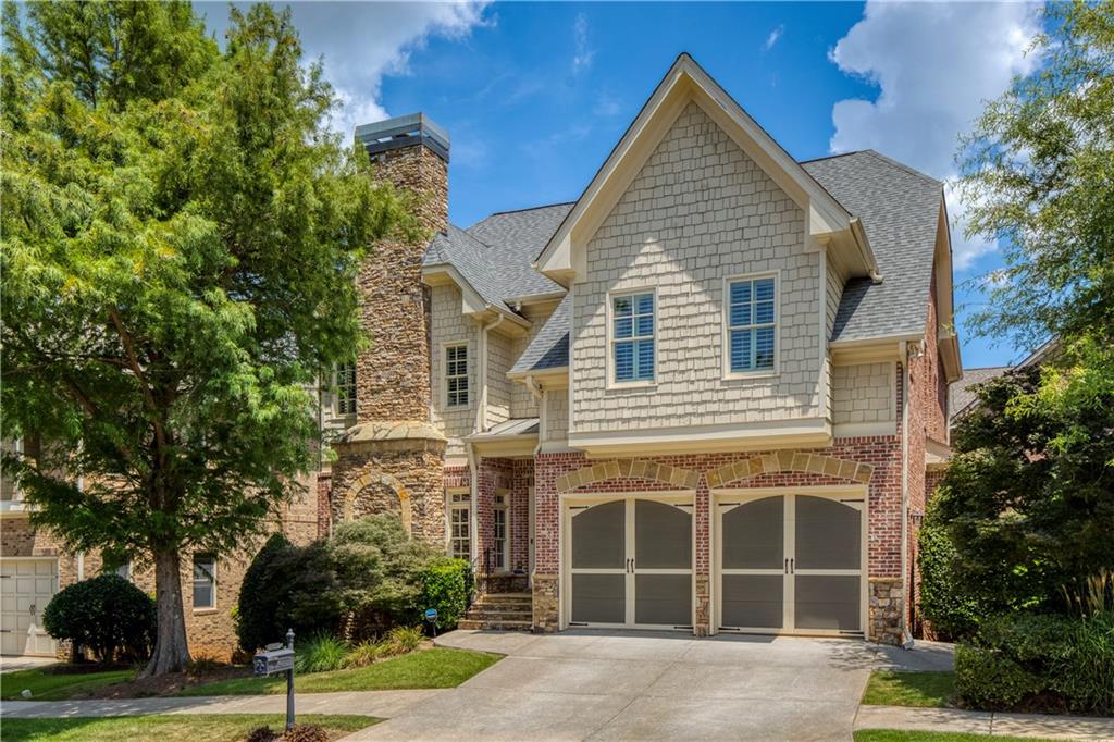 Welcome to Parkside Manor, a sought-after community with award winning schools, short walking distance to famous Webb Bridge Middle School, and directly adjacent to beloved Webb Bridge Park, featuring miles of scenic trails, dog parks, children’s playgrounds, tennis and pickleball courts, and sports fields. With two dedicated private entrances to the park, this neighborhood also offers a large community pavilion and a private sparkling pool for residents to enjoy. Also located just a short drive from Avalon, Halcyon, and Downtown Alpharetta, this home offers convenient access to some of the area's best dining, shopping, and entertainment. And with the Webb Bridge Road improvement project underway, the area will soon feature expansive sidewalks, making it even easier to enjoy the nearby Big Creek Greenway’s miles of picturesque trails. This beautifully maintained home perfectly balances comfort and functionality. At its heart is the chef’s kitchen, equipped with a Wolf 4-burner range with griddle, exterior venting, warming drawer, and a convenient butler’s pantry—ideal for both daily living and effortless entertaining. Just outside, a charming deck with trellis creates the perfect setting for al fresco dining. Inside, the spacious formal dining room features a cozy fireplace, while the family room showcases a striking stacked-stone fireplace, providing warm and inviting spaces for gathering and relaxation. The main level also includes a guest suite with a private en suite bath, offering comfort and privacy for visitors. Upstairs, the oversized primary suite serves as a serene retreat, complete with a private sitting area and its own fireplace. The finished terrace level expands your living space with a private office and a flexible area ideal for movie nights, game days, or entertaining guests. Step outside to the fieldstone patio and enjoy the peaceful ambiance of the backyard. Thoughtful updates include new carpet (2023), refinished hardwood floors (2023), fresh interior paint (2023), water heater (2023), and roof (2020). Don’t miss your opportunity to live in this remarkable home and location!