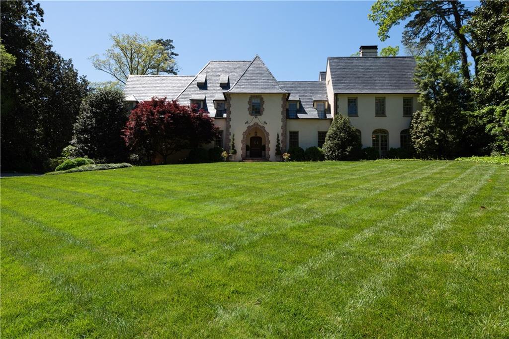 Stately Neel Reid property on revered and coveted Habersham Road. The home is perfectly situated on the Quintessential Peachtree Heights Park rolling front lawn. Traditional entrance hall leads to oversized living spaces, ideal for entertaining. Thoughtfully renovated kitchen by Norman Askins and Matthew Quinn, Design Galleria offers a seamless transition to the family room with a wall of French Doors. Upper level staircase leads to 5 spacious bedrooms including oversized fireside primary suite with sitting room. Recently renovated primary bath connects to the large walk-in closets. There is also a separate upstairs gym. All bathrooms have been renovated as well. Beautiful 3+ acres of manicured grounds include heated saline pool, tennis court, picturesque lawn in the backyard. Property also includes detached guest house with living room, kitchen, bedroom and bath, as well as a pool house with game room. Owners have completely renovated this one-of-a-kind property.