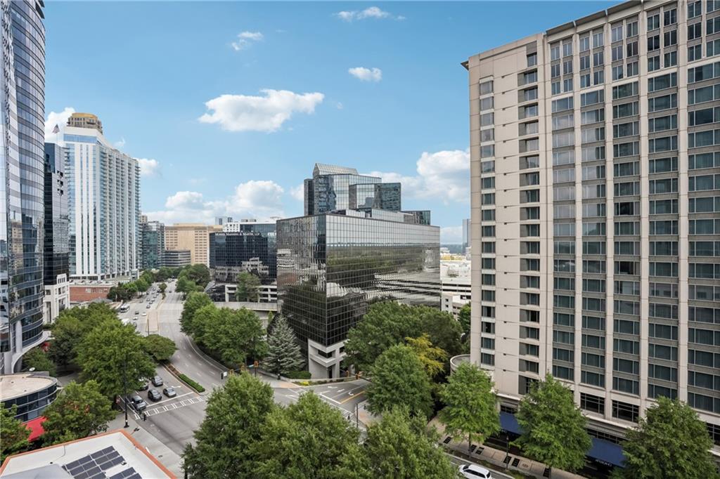 Live above it all in this luxurious 2-bedroom, 2-bathroom residence at Realm Buckhead, where breathtaking city views greet you from every room. This move-in ready home features floor-to-ceiling windows, rich hardwood floors, and a spacious open layout designed for both comfort and entertaining. The upgraded kitchen is a showstopper, complete with custom backsplash, sleek stainless-steel appliances, custom countertops, and a generous bar area perfect for casual dining or hosting guests. The expansive living space is enhanced by designer light fixtures creating a warm and inviting atmosphere. Retreat to the serene primary suite with a custom walk-in closet and a spa-inspired bathroom featuring a frameless glass shower/tub combo and elegant vanity. The split-bedroom layout offers a versatile second bedroom with ample closet space—ideal for guests, a home office, or flex space. Step out onto your private balcony to soak in the skyline, and enjoy the convenience of two secure, side-by-side parking spots. High-speed internet is included in the HOA, and the building offers unmatched amenities: 24-hour concierge, saltwater pool with sun deck, two-level fitness center, upgraded clubrooms with a 24-hour coffee and tea bar, gas firepit, and a private pet park. Located in the heart of Buckhead, you’re just steps from top-rated restaurants, luxury shopping, vibrant entertainment, and MARTA. With easy access to major interstates and backroads, this is city living at its finest.