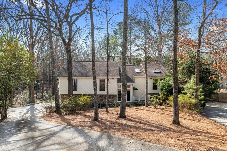 Back on market due to no fault of the seller! Tucked away in the peaceful Rivermont neighborhood, this beautiful 3-bedroom home sits on a private wooded cul-de-sac lot with the perfect location and zoned for highly sought after schools. Inside, you'll find real hardwood floors, soaring ceilings, and skylights bringing in tons of natural light throughout. The expansive two-level deck stretches across the back of the house, providing a perfect spot to relax and enjoy views of the serene, low maintenance backyard. The kitchen has been thoughtfully updated with sleek granite countertops, modern cabinetry, and stainless steel appliances. Each of the three bedrooms features spacious walk-in closets, with the master suite offering a vaulted ceiling, a updated en-suite bathroom, and direct access to the back deck. The fully finished basement offers additional living space, with a large recreation room, wet bar, half bath, and walk-out access to the covered back deck, making it ideal for gatherings and entertaining.
Rivermont is an exclusive North Fulton community, known for its premier amenities, including the nearby Rivermont Park, a private 27-acre riverside retreat with walking trails, playgrounds, and a community stage for concerts during the warmer months. Residents also have the opportunity to join the Rivermont Golf Club, a hidden gem that offers an exceptional golfing experience, with discounted social memberships available for homeowners.
Conveniently located near GA-400, Roswell, and Alpharetta, this home offers the perfect combination of seclusion and accessibility, making it an ideal retreat from the everyday hustle and bustle.