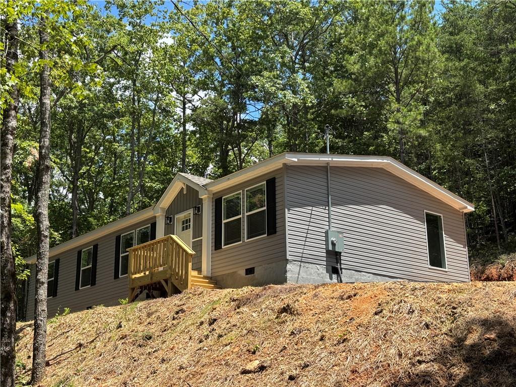 Brand new manufactured home on permanent foundation. Brand new private well, new septic tank. Landscaped yard with sod. Brand new asphalt driveway. You cannot beat the privacy from this home. Such quiet and peaceful property. 3 bedrooms, 2 full bathrooms, 2 separate living room areas, built in shelving. Master bath with tiled shower. Home comes with 1 year warranty. Agent is owner.