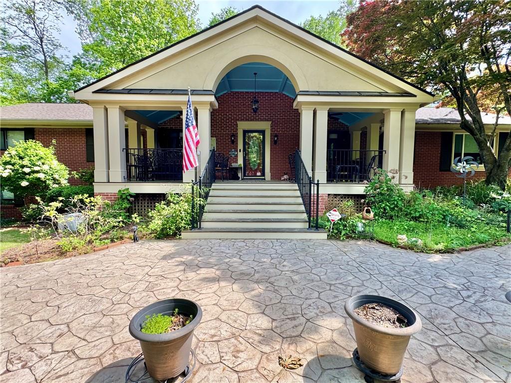 Welcome to the 431 Loop—Where Charm, Craftsmanship, and Comfort Converge on 1.11 Glorious Acres.
Nestled in a coveted neighborhood, this unforgettable Southern beauty invites you in with its grand, Brazilian hardwood rocking chair front porch—an ideal place to sip morning coffee or greet neighbors in true front-porch fashion. Winding around the home is a charming river stone sidewalk lovingly known as “The 431 Loop,” setting the stage for strolls through manicured gardens bursting with perennials, mature Japanese maples, blooming jasmine along the fence line, gardenias, blooming hydrangeas, and many other perennials offering beauty in every season. This is not just a home—it’s a sanctuary for gardeners, dreamers, and those who crave a deep connection with nature.
Step through the front door into a home where timeless quality meets thoughtful design. You’ll find a formal living room and dining room, perfect for holiday gatherings and quiet dinners alike. The heart of the home—the eat-in kitchen—flows into a spacious family room that opens into a sun-drenched sunroom wrapped in UV-blocking glass. Here, you’ll find serenity in every season, whether curled up with a book or watching goldfish dance in the backyard pond.
The kitchen is a chef’s delight with a gas cooktop and instant hot water from the gas water heater. For grill enthusiasts, there’s a gas line to the deck, making outdoor cooking effortless. Just off the sunroom, two decks overlook a backyard oasis with a waterfall-fed pond, and a forested backdrop that offers beauty and privacy year-round.
On the main floor you’ll find four generously sized bedrooms, including a handicap-accessible primary suite with double closets and a built-in safe. Downstairs, the finished basement space is more than just bonus space—it’s a retreat. It features a cozy living area with a wood-burning stove, a library or office with built-in bookshelves, a spacious bedroom with an en suite bathroom, and its own private entrance. Notably, this was once the residence of the first pastor of the First Baptist Church, adding a layer of local history and warmth.
Need storage? There’s a two-car garage, an additional parking pad, a dedicated storage shed, and a separate woodshed just outside the basement—perfect for fueling your fireside nights.
You’ll appreciate features like a central vacuum system, 6-inch gutters with leaf guards, and an attic built with sturdy antique redwood, which speaks to the quality and craftsmanship that runs throughout this remarkable home.
This property is more than a residence—it’s a lifestyle. From the sunlit front yard to the wooded backyard, from its rich history to modern conveniences, every inch of this home has been lovingly curated for comfort, beauty, and functionality.
Come experience the magic of the 431 Loop-Omni’s Garden located conveniently to Kennestone Hospital, Interstate 75, and the Marietta Square. Homes like this don’t come along often.