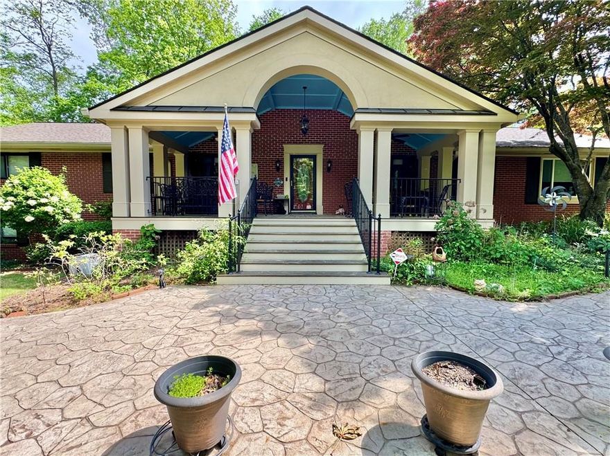 Welcome to the 431 Loop—Where Charm, Craftsmanship, and Comfort Converge on 1.11 Glorious Acres. 

Nestled in a coveted neighborhood, this unforgettable Southern beauty invites you in with its grand, Brazilian hardwood rocking chair front porch—an ideal place to sip morning coffee or greet neighbors in true front-porch fashion. Winding around the home is a charming river stone sidewalk lovingly known as “The 431 Loop,” setting the stage for strolls through manicured gardens bursting with perennials, mature Japanese maples, blooming jasmine along the fence line,  gardenias,  blooming hydrangeas, and many other perennials offering beauty in every season. This is not just a home—it’s a sanctuary for gardeners, dreamers, and those who crave a deep connection with nature.

Step through the front door into a home where timeless quality meets thoughtful design. You’ll find a formal living room and dining room, perfect for holiday gatherings and quiet dinners alike. The heart of the home—the eat-in kitchen—flows into a spacious family room that opens into a sun-drenched sunroom wrapped in UV-blocking glass. Here, you’ll find serenity in every season, whether curled up with a book or watching goldfish dance in the backyard pond.

The kitchen is a chef’s delight with a gas cooktop and instant hot water from the gas water heater. For grill enthusiasts, there’s a gas line to the deck, making outdoor cooking effortless. Just off the sunroom, two decks overlook a backyard oasis with a waterfall-fed pond, and a forested backdrop that offers beauty and privacy year-round.

On the main floor you’ll find four generously sized bedrooms, including a handicap-accessible primary suite with double closets and a built-in safe. Downstairs, the finished basement space is more than just bonus space—it’s a retreat. It features a cozy living area with a wood-burning stove, a library or office with built-in bookshelves, a spacious bedroom with an en suite bathroom, and its own private entrance. Notably, this was once the residence of the first pastor of the First Baptist Church, adding a layer of local history and warmth.

Need storage? There’s a two-car garage, an additional parking pad, a dedicated storage shed, and a separate woodshed just outside the basement—perfect for fueling your fireside nights. 

You’ll appreciate features like a central vacuum system, 6-inch gutters with leaf guards, and an attic built with sturdy antique redwood, which speaks to the quality and craftsmanship that runs throughout this remarkable home.

This property is more than a residence—it’s a lifestyle. From the sunlit front yard to the wooded backyard, from its rich history to modern conveniences, every inch of this home has been lovingly curated for comfort, beauty, and functionality.

Come experience the magic of the 431 Loop-Omni’s Garden located conveniently to Kennestone Hospital, Interstate 75, and the Marietta Square. Homes like this don’t come along often.