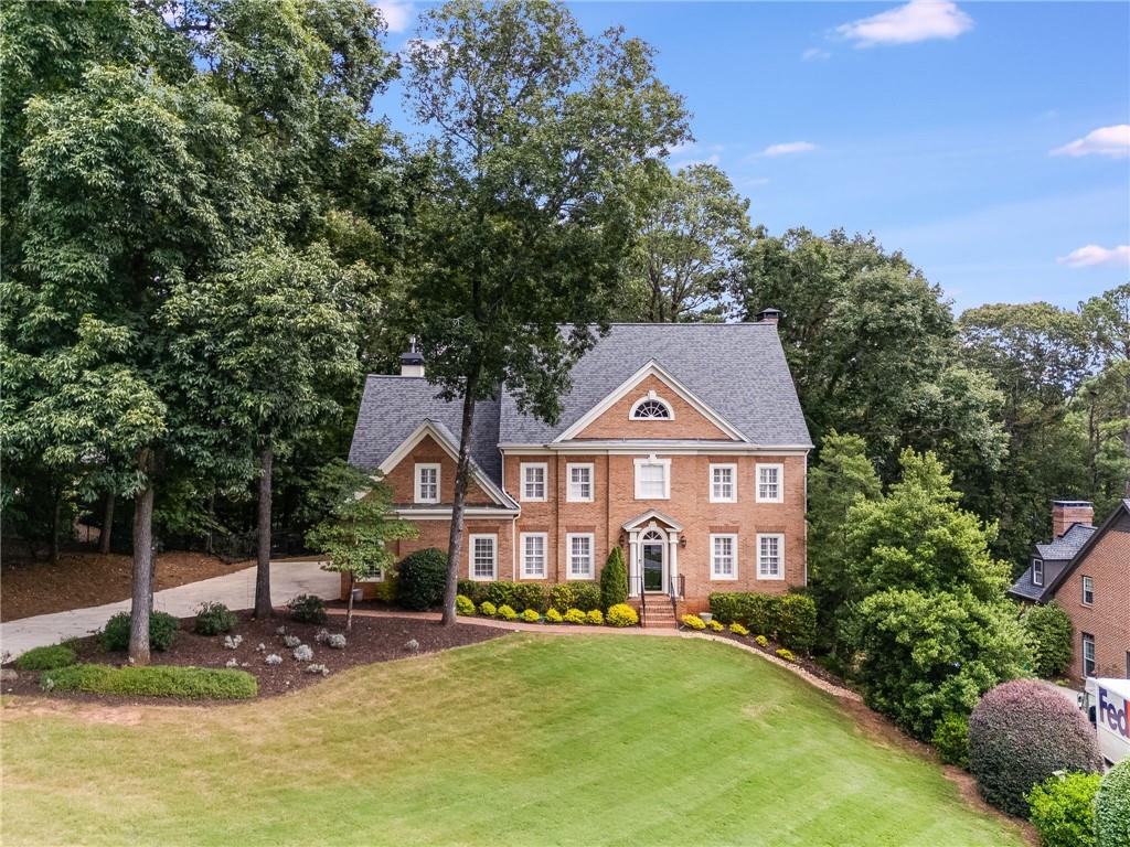 Welcome to this beautiful 5 bedroom, 4.5 bathroom executive residence located in a sought-after community with convenient access to major Atlanta roadways. Situated on a lush almost 0.5-acre lot, this home offers an exceptional layout designed for both everyday living and entertaining.
Step inside the grand foyer leading to a formal dining room and a versatile office/sitting room. The open living room with fireplace flows seamlessly into the chef’s kitchen, featuring a gas cooktop, abundant prep space, built-in desk, and breakfast bar overlooking the keeping room with a French-tiled fireplace. A sun-filled sunroom provides the perfect spot for morning coffee or afternoon relaxation.
Upstairs, the spacious primary suite includes two custom walk-in closets, dual vanities, and a jetted soaking tub. Additional bedrooms are generously sized and well-appointed. The daylight basement features a private bedroom and multiple bonus living spaces, ideal for a home gym, playroom, or media area.
Recent updates include fresh interior paint and new landscaping, ensuring this home is move-in ready.
