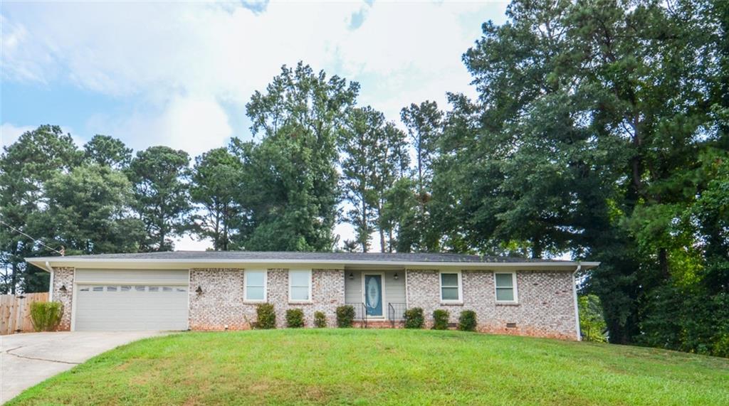 Welcome to 204 Caboose Lane, an updated brick-front ranch nestled in a quiet Woodstock neighborhood with no HOA or rental restrictions. This charming 3-bedroom, 2-bath home offers an inviting open floor plan starting with a welcoming foyer that leads into a spacious living room and large dining area, perfect for entertaining. The chef’s kitchen is the heart of the home, featuring stainless steel appliances and plenty of counter space. The oversized primary bedroom includes a private en-suite bathroom and direct access to a sunroom that overlooks the expansive, fenced backyard — ideal for relaxing or hosting guests. Two additional generously sized guest rooms share a beautifully refinished hall bath. Thoughtful upgrades include new siding, soffit, fascia, and exterior paint (July 2023), along with a new roof (March 2021) and stunning bathroom renovations completed in 2023. Just minutes from the shops, restaurants, trails, dog parks, and live entertainment of Historic Downtown Woodstock, this move-in ready gem blends modern updates with unbeatable location and flexibility.