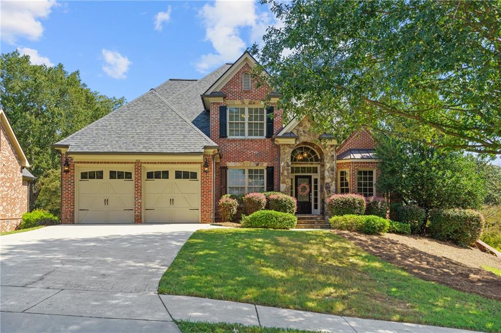 Fall in love with this 4-side brick home on a full unfinished basement, tucked inside one of Gainesville's most desirable small executive neighborhoods - just minutes from downtown! From the moment you step into the vaulted two-story foyer, you'll be welcomed by rich hardwoods and timeless trim details. Just off the foyer, a beautiful home office makes working from home effortless, while a formal dining room sets the stage for gatherings and celebrations. The chef's kitchen with granite counters and custom cabinetry flows seamlessly into the living spaces. A main-level laundry room adds everyday convenience. Retreat to the oversized owner's suite on the main level, where you'll find a spa-inspired ensuite with a tile-surround shower, soaking tub, and dual vanities-your private escape at the end of the day. Upstairs, 4 generous secondary bedrooms with ensuite baths provide space for everyone. The full unfinished basement offers endless opportunities to expand-movie room, gym, or custom in law suite-the choice is yours. Outdoor living is unmatched with two screened-in porches! Enjoy Newer roof, unbeatable location, and true luxury living in the heart of Gainesville. Walk to the Downtown Square for dining, shopping, and community events, with easy access to Lake Lanier, Olympic Park, the University of North Georgia, I-985 and the hospital just 5 minutes away, this home blends luxury, lifestyle, and convenience like no other.