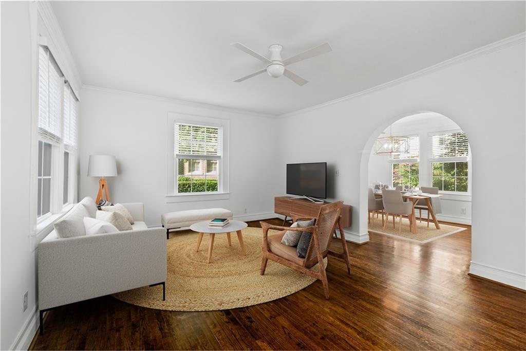 This beautifully maintained and spacious two-level corner condo offers a rare opportunity to own a residence of both character and convenience in one of Buckhead's most sought-after communities, Peachtree Commons. Tucked quietly off Peachtree Street, this home is perfect for the Buyer who wants charm AND space in an incredible location. Inside, the home is flooded with natural light and features original hardwood flooring, crystal doorknobs, and graceful arched entryways that speak to its original architectural and charm. The thoughtfully renovated kitchen is equipped with glass-pane cabinetry, stone countertops, under-cabinet lighting, bead board detailing, and a petite subway tile backsplash. The main level features a dedicated dining room and an oversized living room that leads to a screened-in porch overlooking a serene courtyard provides a peaceful retreat from city life. Downstairs, a dedicated, and rare, laundry room is next to the two bedrooms and offers generous closet space and storage. The bedrooms are full of windows and feature perfectly sized closets, and share a full bathroom. Offering a harmonious blend of historic character and modern comfort, this residence represents a unique opportunity to enjoy Intown living in an enviable location within walking distance to a variety of shopping, dining, and entertainment destinations - Houston's being a noteworthy fav.
