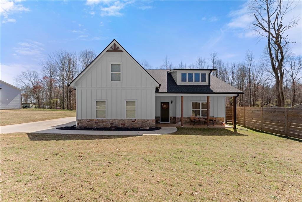 PRICE IMPROVEMENT!!! Custom Ranch-Style Home on 1.29 Acres - No HOA! Welcome to this beautifully upgraded ranch-style home, nestled in an exclusive 12-home subdivision with no HOA restrictions. Situated on a spacious 1.29-acre lot with a privacy fence encompassing a large portion of the lot, this home offers tranquility, modern elegance, and thoughtful upgrades throughout. Step inside through the custom front door and you're welcomed by the deep mahogany LVT flooring. The open concept living area features a cozy wood-burning fireplace, perfect for relaxing on those cold days. The kitchen is a chef's dream, boasting Black Pearl granite countertops, stainless single bowl sink, subway tile backsplash, and oil-rubbed bronze fixtures. Your family will enjoy the convenience of being served at the kitchen island or in the adjacent dining area. The bathrooms continue the luxurious feel with rectangular sinks and a fully tiled owners shower with a glass door and extra rain showerhead. The owner's suite and secondary bedrooms are conveniently located on the main level, while a large fourth bedroom with full bath is situated upstairs, ideal for guests, a teen, or your private home office. Enjoy outdoor living at its finest with a large covered rear patio, custom built, two-tiered deck with a hot tub, a swing set, and a storage shed. This incredible property is a rare find-offering privacy, space, and top-tier finishes with no HOA restrictions! Don't miss your chance to own this stunning home! Schedule your private showing today.