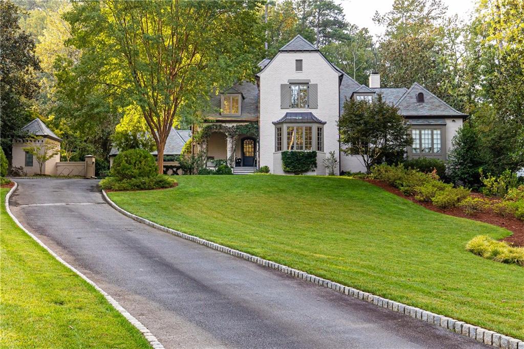 Welcome to the exquisite 358 King Road in Atlanta’s iconic Tuxedo park. Crafted by renowned architect Stan Dixon, this residence boasts 5 bedrooms, 5 full and 3 half bathrooms, occupying a splendid and totally private 1.5-acre parcel of prime Buckhead land.
Upon entering, you are greeted by an inviting foyer that leads to a cozy living space adorned with a fireplace and French doors opening to a covered terrace. The separate dining room overlooks the perfectly manicured front lawn. A true chef's kitchen, with its exquisite design, opens to a  breakfast area and family room, offering captivating views of the landscaped backyard and pool.
The main level also features an owner's suite with sitting room, luxurious spa like bath, and separate his and her closets. Ascend to the second level, where three bedrooms, each with ensuite bathroom, and a bonus room await. The full basement, a haven for entertainment, includes a bedroom and bathroom, wine cellar, gym, and a state of the art theater room.
Above the garage, a finished space awaits, perfect for an office. The meticulously landscaped backyard, envisioned by Pak Heydt, unfolds as a breathtaking oasis with a pool, hot tub, and a spacious outdoor pavilion. This outdoor haven also includes a barbecue area, two fire pits, putting green, and even a charming chicken coop.
Located in highly coveted Tuxedo Park, this home offers luxury living with close proximity to Chastain Park, area private schools, and Atlanta's finest dining, upscale retail, and all the amenities that Buckhead has to offer.