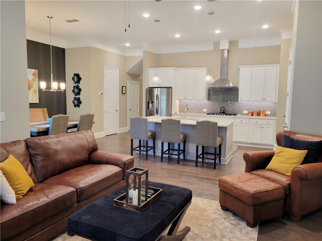 Like NEW! Experience luxury living in this exquisite 2021 single-family home nestled in the heart of an upscale community. As you step into this meticulously crafted residence, you'll be greeted by modern elegance and thoughtful design. This spacious home features high-end finishes, an open floor plan, and state-of-the-art amenities to ensure a comfortable stay. 11 Ft ceilings on Main, 10 ft uppers. This Gourmet Kitchen is a chef's delight with large island and tons of counter space. Quartz countertops & Stainless appliances. Hardwood floors throughout the 1st floor and custom shades, oak tread stairs. Large Owners suite up w/an amazing closet finished out with Spacemaker design. Spa-like bath with separate Vanities and tiled walk-in shower! The exterior patio and deck off the master are both covered. Conveniently located near downtown Woodstock that offers upscale shopping, dining, and entertainment options, this home provides easy access to the best the area has to offer. Awesome Amenities! Gated Community / Excellent Schools / Large, Luxury Clubhouse/Gym / Community Swimming Pool / Pickleball and Bocce Ball Courts / Outdoor Firepit / Dog Park.