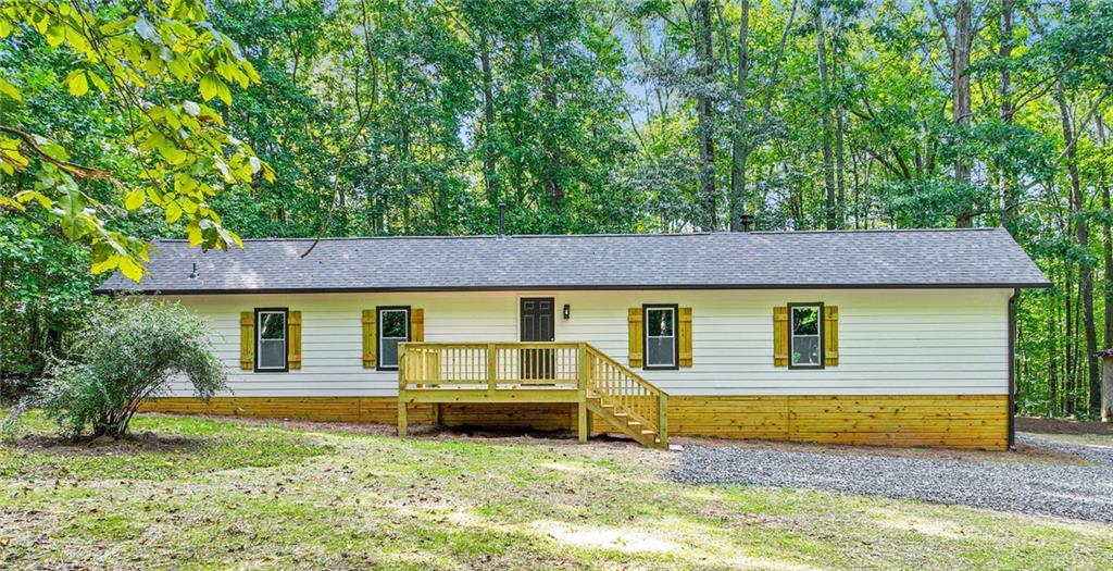 Welcome to your peaceful retreat! This beautifully updated 4-bedroom, 2-bath mobile home is nestled on 2.09 private acres, accessed by an 800-foot driveway that offers privacy and tranquility. Inside, enjoy a bright, open layout and living area. The kitchen features all-new appliances, perfect for everyday living or entertaining. Step outside to a brand new front deck ideal for relaxing and enjoying the quiet surroundings. Modern comfort meets country charm—move-in ready and waiting for you!