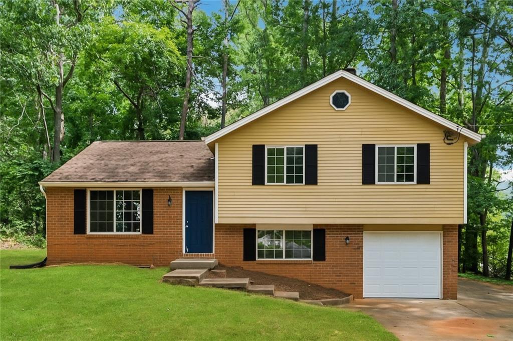 Discover your ideal home at 1984 Singer Way, Lithonia, GA 30058, a charming residence nestled in a sought-after neighborhood. This inviting home boasts a fresh and modern interior with newly painted walls, creating a bright and welcoming atmosphere. Situated on a spacious corner lot, the property offers excellent curb appeal and ample outdoor space. Step outside to the relaxing rear deck, perfect for hosting gatherings or enjoying quiet evenings. The home features a convenient garage, complete with a brand-new door and opener for secure and easy access. Inside, a versatile space awaits, ideal for use as a cozy sitting area or a productive home office, highlighted by a warm brick fireplace that adds character and charm. Stay comfortable year-round with a new exterior HVAC unit. Don’t miss the chance to own this beautifully updated home, blending style, comfort, and functionality in a prime Lithonia location. Schedule a showing today to experience all that 1984 Singer Way has to offer!