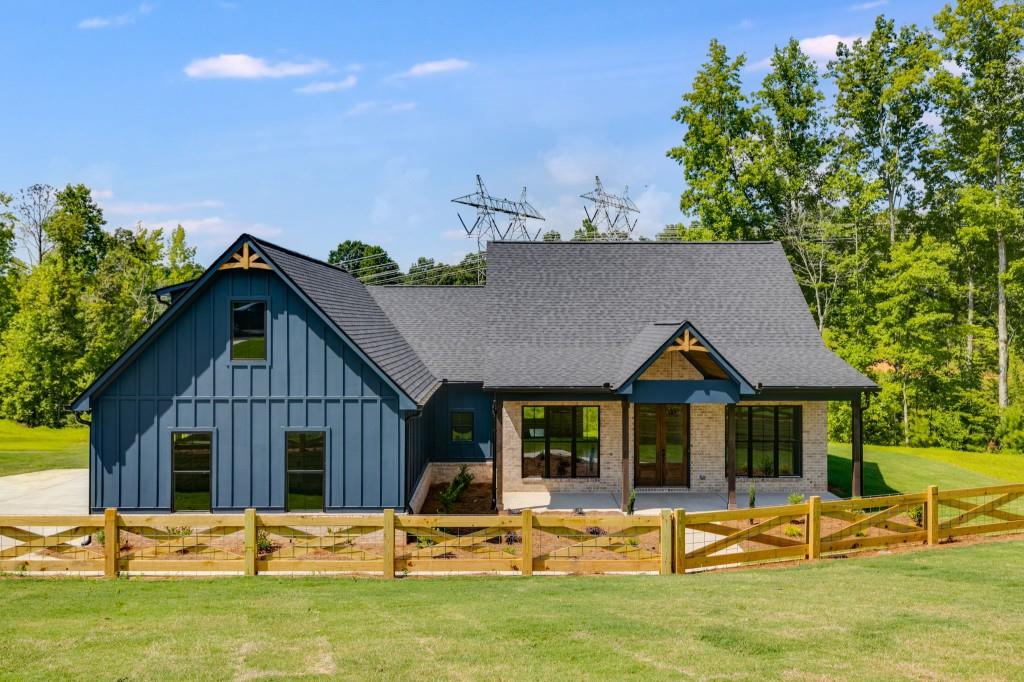 Welcome to this brand new ranch-style home situated on over 4.5 acres of beautiful land on Ridgewood Creek Path, Lot 9. Thoughtfully designed with high-quality finishes throughout, this home offers the perfect blend of modern comfort and country charm. Inside, you'll find an open-concept layout featuring a spacious living area filled with natural light, a beautifully appointed kitchen with stylish countertops and cabinetry with a farmhouse sink, and a smart split-bedroom floor plan that provides privacy and functionality. The main level includes three generously sized bedrooms, while upstairs you'll find a large fourth bedroom complete with its own private bathroom ideal for guests, teens, a home office, or a private retreat. The expansive yard offers plenty of room for outdoor activities and gardening. If you're looking for peaceful rural living this property delivers. Conveniently located just minutes from local schools, shops, and everyday amenities, this home offers the best of both worlds quiet, scenic surroundings with easy access to town. Don't miss your chance to own this stunning new construction home on acreage!
