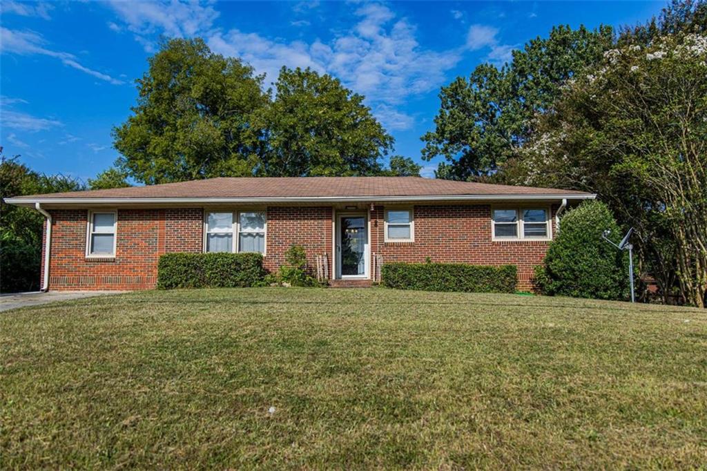 Great four sided brick home features 3 bedrooms, 1 bath, timeless hardwood floors in the living room, kitchen and all the bedrooms. Spacious den with built in cabinetry - great for storage, display or even a home office set up. The private backyard has a privacy fence great for relaxing, entertaining or pets AND an outbuilding! The sellers are in the process of replacing all the galvanized plumbing from the home to the road!!! Great home, move in ready!!!