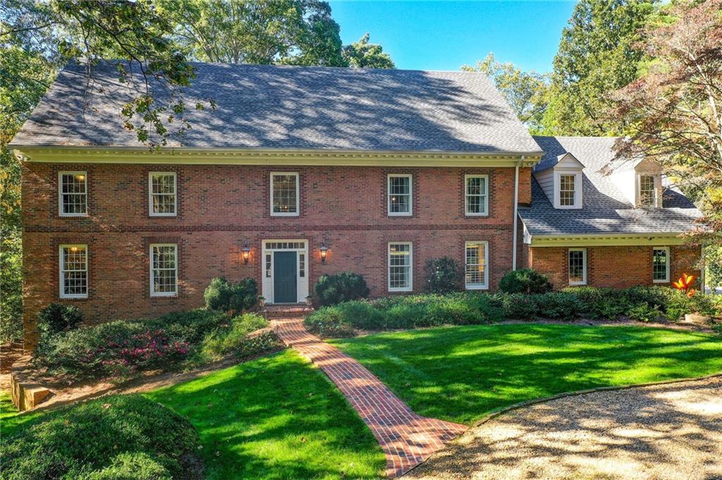 Welcome to 1710 Winterthur Close an exceptional estate on the banks of the Chattahoochee River in the prestigious Winterthur community. Nestled on 2.39 private acres, this beautifully renovated brick traditional combines timeless architecture with modern luxury. Drive up to this level, beautifully landscaped lot where a graceful circular driveway and impeccable curb appeal set the tone for the elegance that awaits inside. Offering 7 bedrooms and 5 full bathrooms, this home provides expansive spaces for both elegant entertaining and comfortable everyday living. The main Level living includes a beautiful  kitchen and keeping rom with custom tongue-and-groove ceilings with beams.  This chef's  kitchen  features quartz  countertops, custom cabinetry, an 8 foot  island, top-of-the-line Wolf, Sub-Zero and Cove appliances. Kitchen opens to a keeping room which has floor to ceiling windows and a custom built-in bar and entertainment area, perfect for gatherings. The main level  living has hardwood flooring and a beautiful vaulted fireside living room, a banquet-size dining room, and a charming sunroom with brick flooring and floor-to-ceiling windows overlooking the backyard and Chattahoochee River. The primary suite on the main level includes double closets, a dressing room and a spacious bath. The main level also has a convenient mudroom/laundry room from the walk in garage and  a guest full bathroom.  Upstairs are four additional spacious bedrooms with great closets, including two en-suite bedrooms, along with an office/media-game room or an adult or teen hang out room over the garage. The terrace level offers ideal space for multi-generational living or guests, with a kitchen, en-suite bedroom, bunk room, gym, and  a must see media/pool room. Enjoy resort-style amenities with a heated pool and spa, expansive patios, decks and  lawn areas designed for al fresco dining, poolside lounging, and entertaining. Situated on a quiet street  in one of Atlanta’s most distinguished riverfront neighborhoods, this rare river-lot property combines privacy and convenience. Located minutes from I-75, 400, and 285, it’s also close to Atlanta’s top private schools and award-winning Heards Ferry and Riverwood school districts. Just minutes from the heart of Sandy Springs with all Sandy Springs has to offer including shopping, great restaurants, City Springs, Whole Foods and  Trader Joes. Close to Buckhead, downtown and the airport. The home also includes 2  tankless water heaters,  a generator and a whole house water softener 1710 Winterthur Close  offers unparalleled privacy, natural beauty, and timeless elegance—a true must-see for those seeking luxury riverfront living. Living in Winterthur means more than owning a home—it’s a lifestyle while enjoying  your own private view of the Chattahoochee River.