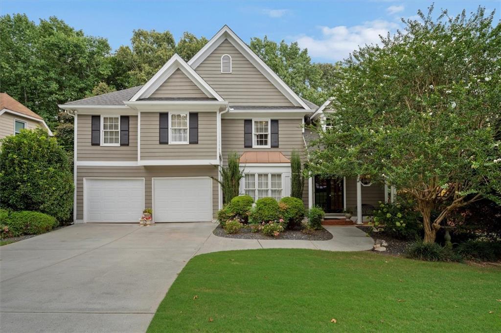 Nestled privately among the trees, and beautifully landscaped, this spacious, well lit, traditional home is located in the popular Remington Trace neighborhood just 2 miles from I-75 and a ½ mile to the Hickory Grove Express Lane.
The double French doors and architecturally dramatic two-story foyer welcome you to this well-designed, open floor plan featuring a living room with 20 ft cathedral ceiling, fireplace and a large formal dining room. The kitchen features granite countertops/tiled backsplash, abundance of custom cabinetry, planning desk plus butcher's pantry. The casual dining area, adjacent to the kitchen, leads to the screened in porch perfect for morning coffee and the deck complete with a gas hook up for setting up a BBQ. Conveniently located from the kitchen is a spacious laundry room. The hardwood flooring of the entire main level leads to the carpeted upstairs loft and Palladian window feature, master suite with double tray ceiling, his and hers closets and a master bath with a large double vanity, whirlpool tub and separate shower. The 3 upstairs bedrooms are light and airy with access to an oversized full bath with skylight and linen closet. The large, finished basement is perfect for a 5th bedroom or an in-home office.
It’s a short walk to the large neighborhood pool, playground, and tennis courts with low annual HOA dues and close to downtown Acworth restaurants, parks, and events.