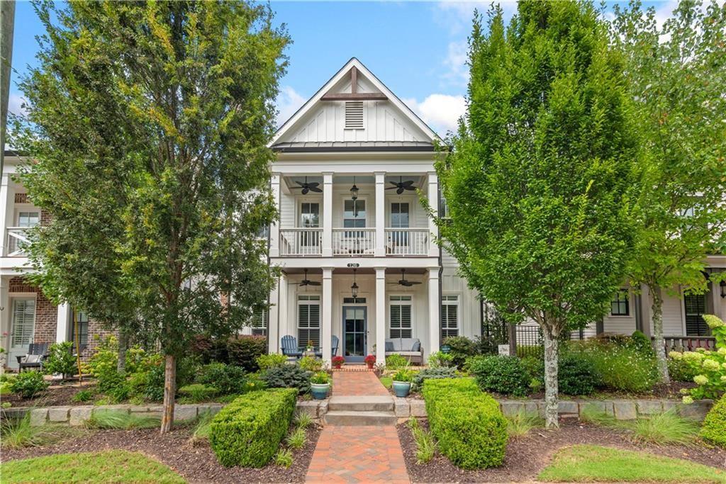 This is the ultimate downtown living opportunity you’ve been waiting for! You’ll fall in love with this exquisite and spacious home loaded with over $100K of special features and upgrades, all designed to enhance your everyday life. The most charming double porches welcome you. Upon entering this stunning home, you’ll appreciate the upgraded rich wide-planked LVP flooring and the soaring 10 foot ceilings throughout the main floor. The two spaces located at the front of the home are perfect for elegant dinners and cozy fireside evenings. The study also does double duty with its specially designed built-in cabinet that serves as a tucked away desk/office. Also, the gracious dining room seats at least eight guests with easy access to a built-in butler’s pantry/bar that’s ready for service. The back half of the main floor offers a casual, open space for relaxed living and entertaining. Enjoy a beautiful, well-equipped kitchen with KitchenAid and GE Profile appliances including a double oven. There’s a perfect sunny breakfast area, just the place for enjoying morning coffee – all open to a very spacious and stylish great room, boasting a modern stone fireplace, flanked by stained floating shelving. This main floor is conveniently located steps from the 2-car garage, making unloading groceries a breeze. Complimenting this amazing space you’ll note other custom upgrades like a designer ceiling fan, island pendants, gold-tones hardware, upgraded sink faucet and other lovely light fixtures. And, don’t miss the smartly designed custom pantry and closet. The second floor does not disappoint with four spacious bedrooms, including a sumptuous primary suite complete with a fabulous sitting area and private screened porch. The primary suite features a stunning spa-like bath with simply the best amenities: oversized walk-in shower, dual granite topped vanities, free-standing slipper tub ready to spoil you, and two enormous fully custom designed closets that will simply wow you. There’s no home in this price point that offers a primary suite like this! The lovely secondary bedrooms have access to well-appointed baths, more custom closets and the second story porch with a view of downtown Alpharetta. One more (a third) floor awaits currently used as an inviting den with a full bath that is perfect for movie nights or game day. Another unique feature of this home is the two walk-in storage spaces located on the third level…there’s definitely no lack of storage here! The garage provides even more storage with its motorized lifts plus there’s a epoxy finished floor and wiring for an EV charger. The cu degras is the most enchanting porch and side patio with its lush professional landscaping, fun party lights strung all around, stepping stones and planters brimming with greenery. It’s one heavenly escape from the everyday hustle and bustle. This home offers the ultimate location, just a few minutes’ walk to all of the fun, action and excitement of downtown Alpharetta’s shopping, dining, and popular events like the Brew Moon Festival, Taste of Alpharetta and the Songwriter’s Festival…and so much more! And, the amazing Avalon is within walking distance too. If you’re looking for a home that is located in the middle of it all without compromising comfort and space, you’ve found your new home!
