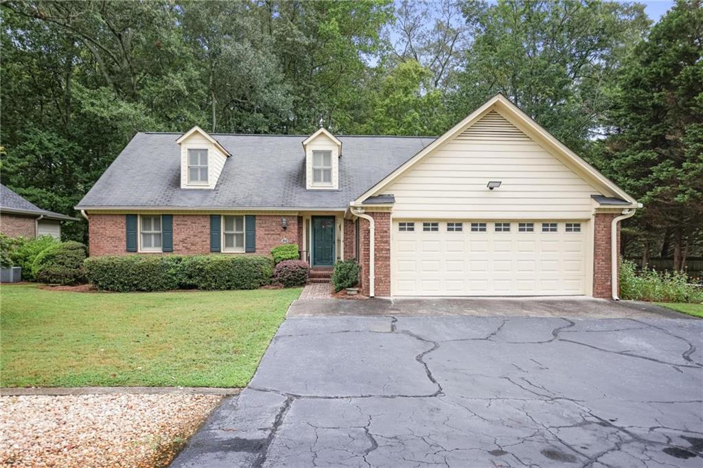 Rare Opportunity – One of Only Two Detached Homes in Sought-After Marietta Ranch Townhome Community, Enjoy the best of both worlds with this unique, detached home located in a small, centrally located ranch-style community in Marietta City. Offering the perfect blend of privacy and low-maintenance living, this home is ideal for those seeking comfort, convenience, and accessibility. Inside, you'll find two spacious bedrooms on the main floor, wide hallways for easy navigation, and a bright, open-concept layout. The kitchen and dining area features granite countertops, stainless steel KitchenAid appliances. The great room boasts cathedral ceilings and flows seamlessly into a cozy, wood-paneled sunroom that opens to a large, private deck—perfect for morning coffee or evening relaxation. Upstairs offers two additional bedrooms, a full bath, a versatile living space, and generous storage throughout. Outside, enjoy tranquil, low-maintenance landscaping, with a natural buffer of mature trees and a peaceful stream creating a private, serene backdrop. Additional highlights include a well-maintained interior and exterior, a 2-car garage, and a location that puts you close to everything Marietta has to offer.
