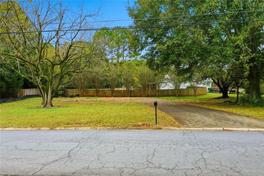 Located in a sought-after East Cobb location, this level, corner lot offers a rare chance to build something truly yours in the Kell High School district. Already cleared and prepped, the lot includes a poured concrete driveway and capped water and sewer lines — a huge head start that saves time and money.
With R-20 zoning in place, the property is ideally suited for a single-family slab home, offering flexibility and convenience for your build. The corner location adds extra curb appeal and access, and the flat terrain means less prep work and more budget for the things that matter inside the home.
No HOA. No teardown. Just a clean slate in a well-established community, minutes from shopping, restaurants, parks, and commuter routes. Bring your vision, your builder, and your dreams. This one’s ready to go.