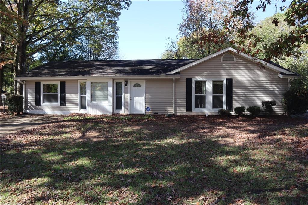 Welcome to Acadia Woods, perfectly situated just outside of downtown Lawrenceville, GA. This recently renovated ranch includes 4-bedrooms and two full baths. Step into a spacious living room with vaulted ceilings and exposed wood beams. Kitchen features new quartz countertops, painted white cabinets, tile backsplash and stainless-steel appliances. Separate dining room and laundry/mud room. Master suite offers its own sanctuary with private access to the outdoors, a walk-in closet and en-suite bathroom. Home features 3 additional secondary bedrooms including one with built-in cabinetry. Private fenced-in back yard with new deck is perfect for kids and pets. Seller has made many recent improvements to the home. Additional bedroom add on, newly installed vinyl double-paned windows, new Lifeproof LVP flooring/baseboards throughout and new recessed lighting/ceiling fans are just a few of the recent renovations. This charming home is a must see!