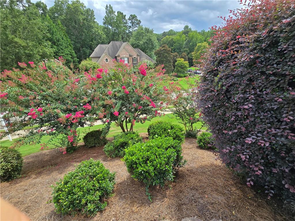 Welcome to this beautiful Alpharetta home, set on a landscaped corner lot in a quiet cul-de-sac next to The Manor Golf & Country Club. With classic brick curb appeal, mature trees, and a timeless exterior, it makes a great first impression. Inside, large windows fill the home with natural light, highlighting high ceilings and open spaces made for both comfortable living and entertaining. There’s a bright two-story great room, a chef’s kitchen with quality finishes, and a finished terrace level with its own entrance—perfect for guests, multigenerational living, or working from home. Upstairs, the primary suite is a relaxing place to unwind. A three-car garage provides plenty of space for vehicles, hobbies, or a workshop. Outside, a private deck overlooks the spacious, quiet, level backyard with mature landscaping for extra privacy. The covered porch offers a quiet spot to enjoy, and could be expanded into a sunroom or even a whirlpool area for year-round use. Whether you’re enjoying morning coffee or evenings under the stars, the indoor-outdoor layout works beautifully. The location is hard to beat, with quick access to GA 400, top-rated schools, parks, shopping, and dining all nearby.
