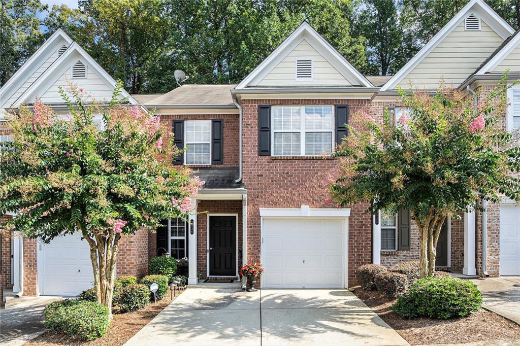 Beautiful immaculately maintained 2 bed, 2.5 bath home with NEW HVAC and NEW Water heater in sought after Laurel Oaks community with an open floor plan. Beautiful hardwood floors throughout the main level and carpet in stairs and bedrooms of upper level. Family room has soaring vaulted ceiling, contemporary floor-to-ceiling fireplace and views from the kitchen and dining area. Kitchen features gorgeous granite countertops, a beautiful backsplash and fabulous stainless steel appliances. Updated fixtures throughout the home like new light fixtures, new paint in bedroom, living room and kitchen, new hvac system, new water heater. Master bath features granite countertops, a soaking tub with stainless steel fixtures, separate shower and a large walk-in closet. Laundry conveniently located upstairs in the hallway. Secondary bedroom is spacious with its own bathroom that features granite countertops and tub/shower and walk-in closet. Community features 24 hour surveillance, sidewalks, and plenty of guest parking. Living in this great community will give you easy access to interstate I-85, Pleasant Hill Road, walkability to grocery stores, Corley elementary school, restaurants, and entertainment. Low HOA dues covers exterior, landscaping, termite, and pest control. Hurry! This one won't last.