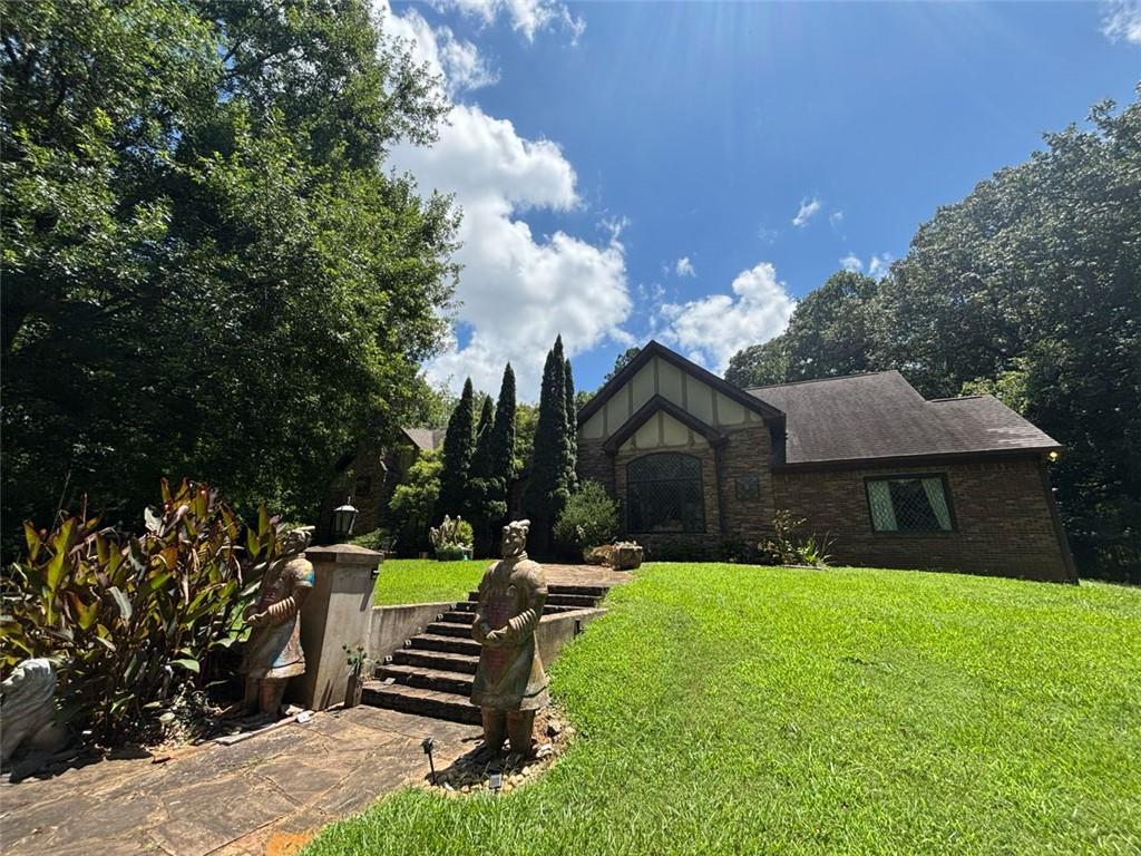 Welcome to this one-of-a-kind gated estate, offering unmatched versatility for short-term rentals, events, business ventures, or private living. Set on 3.62 acres of picturesque land, this rare British Tudor-style home, crafted from elegant brick and stone, overlooks a serene lake, with a second tranquil lake just beyond its borders.
Inside, you'll find 4 spacious bedrooms and 3 beautifully designed bathrooms, complemented by stunning architectural features such as marble flooring, 100% wool carpeting, stained glass windows, and exposed wood beams. The home is being sold fully furnished, with unique vintage pieces that enhance its timeless character.
A 720 sq ft garage offers ample space for storage, parking, or potential studio conversion.
This estate has been featured in numerous film and TV productions, including Netflix’s "Dumb Money," Disney+’s "The World According to Jeff Goldblum," and BET’s "Magic City," making it not only a beautiful residence but also a proven filming location.
Zoned for both office and institutional use, this property offers endless possibilities—ideal for a business retreat, wellness center, creative studio, or live/work setup