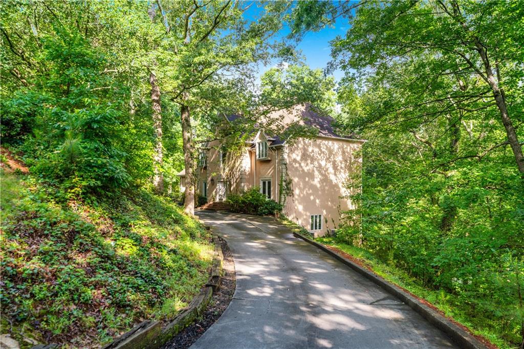 Experience Everyday Luxury in This Stunning Sandy Springs Retreat!
From the moment you step into the grand marble foyer, you’re welcomed into a world of elegance, warmth, and refined living. Rich hardwood floors flow throughout spacious living areas, setting the tone for comfort and style. A main-level guest suite offers the perfect blend of privacy and hospitality, ideal for overnight guests or multigenerational living.
The gourmet eat-in kitchen is a chef’s dream, featuring solid surface countertops, custom cabinetry, and high-end stainless steel appliances. Massive windows fill the home with natural light and frame tranquil, tree-lined views, turning every meal into a serene, elevated experience.
Upstairs, the primary suite is a true sanctuary. Unwind in the luxurious sitting area, enjoy the spa-inspired en-suite bath with a soaking tub and separate shower, and take advantage of an expansive walk-in closet that’s as functional as it is indulgent.
Adding to the charm, one of the oversized bedrooms includes a fun, built-in loft, a perfect kids’ hangout or creative nook, designed for play, reading, or imaginative adventures.
Lovingly maintained by a single owner and never before offered for sale, this home has a unique charm and warmth that only time and care can create. While it offers tremendous quality and craftsmanship throughout, a touch of updating could transform it into your dream space, an exciting opportunity to make it truly your own.
The full, finished basement provides a wealth of possibilities, ideal for a home theater, entertainment lounge, gym, or recreation space, crafted for effortless luxury living.
Step outside and you’ll discover three tiers of balconies, each offering the feel of private treetop terraces with unmatched privacy and peace. The top deck is a secluded sanctuary, while the resort-style in-ground pool delivers the perfect touch of indulgence and summer fun.
Charming architectural details like built-in window seats, oversized front bedrooms, and light-filled interiors bring warmth and personality to every corner of this stately home.
Set in a quiet, upscale neighborhood of beautifully maintained properties, this exceptional residence offers the perfect blend of serenity and convenience, just minutes from everything North Atlanta and Sandy Springs have to offer.
This is luxury living at its finest, uniquely elegant, thoughtfully lived-in, and ready to welcome its next chapter. Don’t let this rare gem slip away. Schedule your private tour today!