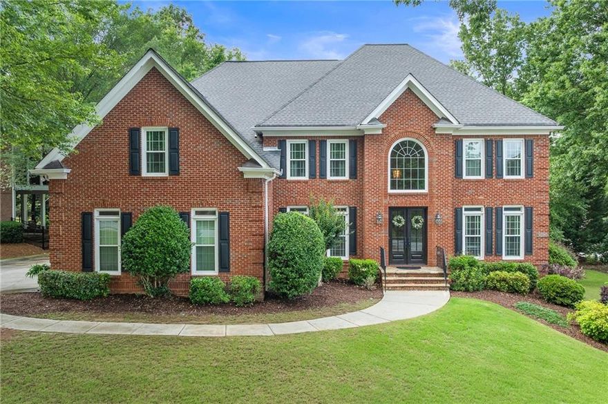 Welcome to this exceptional 6-bedroom, 6-bathroom brick home located in a highly sought-after Alpharetta swim/tennis community. Perfectly situated on a private, wooded corner lot, this property offers timeless curb appeal and a long list of impressive upgrades that set it apart. Step into the soaring 2-story foyer where gleaming hardwood floors and abundant natural light create a warm and elegant welcome. The main level features a formal living room and dining room, ideal for hosting gatherings, while the 2-story family room boasts a dramatic wall of windows, a cozy brick fireplace, and an open, airy feel.

The chef’s kitchen is beautifully designed with a large center island, white cabinetry, quartz countertops, stainless steel appliances, gas range, built-in wine rack, and a sunny eat-in breakfast area. A convenient guest suite is also located on the main level. Upstairs, retreat to the luxurious primary suite complete with vaulted ceilings, a fireplace, and a tranquil sitting area. The spa-like ensuite bathroom features double vanities, a soaking tub, a separate glass walk-in shower, and a massive walk-in closet. Spacious secondary bedrooms offer comfort and flexibility for any lifestyle.

The finished terrace level is a true extension of the home, offering a full bar, game room, exercise room, bedroom, and full bath—perfect for entertaining or multi-generational living. Step outside to a screened-in porch and Trex deck, ideal for grilling and enjoying the beautifully landscaped backyard with turf lawn and private wooded views.

Extensive updates include 26 new windows (2019), basement flooring and carpet (2020), Trex deck and porch (2016), backyard turf (2019), two new furnaces and AC units (2024), refrigerator, two water heaters (2022), and Dog Watch electric fence (2021). The roof was replaced in 2010.

Enjoy resort-style neighborhood amenities including a pool, tennis and pickleball courts, clubhouse, playground, community dock, fishing lake, and business center. Zoned for top-rated schools and just minutes from shopping, dining, parks, and major commuter routes, this stunning home offers the perfect blend of luxury, space, and location. Don’t miss this rare opportunity!