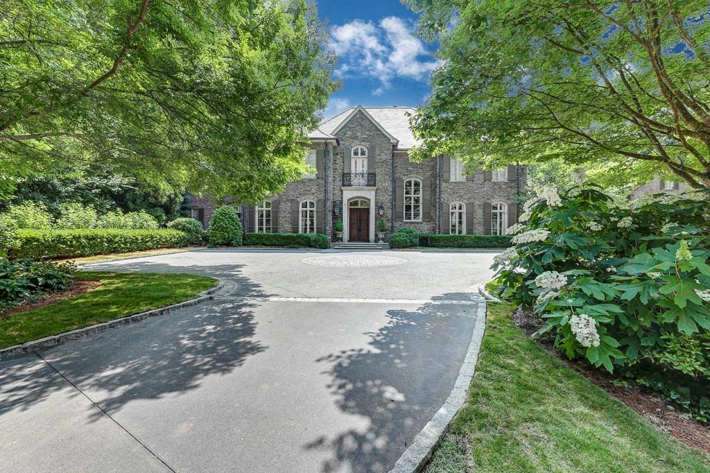 Welcome to one of the most beautifully built homes in Buckhead! Located on 3.4 +/-  private, gated acres. This home features a stunning entry with lovely staircase leads to handsome paneled library, banquet sized dining room and living room with floor to ceiling iron windows overlooking beautiful pool and expansive backyard.  The primary suite is located on the main level with his/her baths, large closets.  There is an elevator, 11 to 12 foot ceilings, family room with large fireplace and exposed beams in the breakfast room (and kitchen) which has floor to ceiling iron windows.  Stunning new kitchen with incredible natural light. There is a 4 car garage with one additional covered space.  Beautifully finished lower level with gym, gorgeous wine cellar, theater, bar/kitchen, stunning paneled office with fireplace, guest suite with sitting area and rec room.  2 laundry rooms and seven fireplaces.