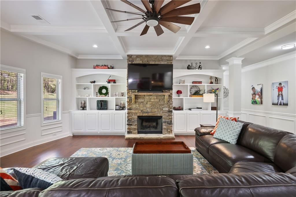 Located at 1622 Bunting Forest Court in Marietta, GA, this stunning 6-bedroom, 5-bathroom home with inverted basement offers nearly 6,140 square feet of thoughtfully designed living space on a beautifully landscaped 0.49-acre lot. The beautifully landscaped front yard welcomes you in through the two story foyer to the formal front room and dining room. The open floor plan on main features a large eat in kitchen, breakfast room, and great room with built-in bookcases and cozy stone fireplace. A full bathroom and guest room finish out the first floor. The second floor is home to a great media/play room, built-in work stations, two bedrooms, a full bath, laundry room, and the primary suite. The primary suite is home to an oversized bedroom, sitting room, spa like bathroom, and oversized dual sided closet. What makes this home special is the inverted finished basement space on the third floor. Complete with two bedrooms, two full bathrooms, and a bonus room with built in bookcase and bar, this space gives its residents room to expand! Outdoors, enjoy your own private bocce ball court, a spacious covered patio, and a tree-lined yard that offers both privacy and tranquility. Just minutes from Kennesaw Mountain National Battlefield Park, top-rated schools, shopping, dining, and a swim community across the street to join, this energy efficient home offers a rare combination of luxury, location, and lifestyle.