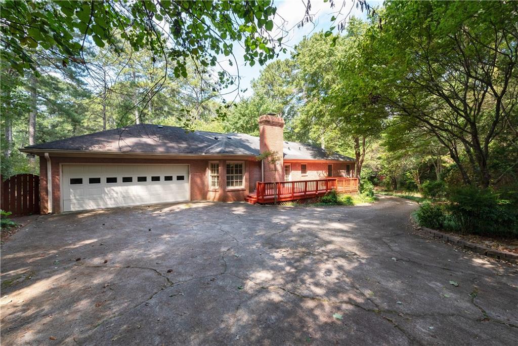 Welcome to this beautiful, 4 sided brick home. Exceptionally built, just needs some updating, great bones to work with! Sold as-is. Circular driveway in front and side driveway to garage in rear of home. Large bedrooms and plenty of space for large families or large gatherings. Huge kitchen overlooking a luscious landscaped backyard and deck.