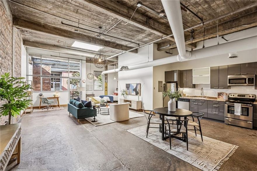 Looking for a place with character? You’ve found it. This authentic 1925 loft has stories to tell—and lucky you, it’s ready for its next
chapter. Original brick walls, exposed beams, concrete floors, and soaring 12-foot ceilings whisper vintage charm while the courtyard views
flood the space with natural light. And let’s talk location: ever dreamed of rolling out of bed and—BOOM!—you’re on the BeltLine with a
coffee in one hand and a breakfast burrito in the other? That’s your new morning routine. Want tacos, ice cream, or a leisurely stroll to
Piedmont Park? All within seconds. Krog Street Market and Inman Park Village are practically your backyard. Forget driving—just park it
and live your best car-free life. This space is as versatile as it is stylish. With an open kitchen, oversized dining area, and spacious living
zone, you can go full HGTV and make it your dream home—or turn it into your dream office, salon, med-spa, or creative studio (it’s zoned
for both work and residential). Basically, if you can imagine it, Studioplex #229 can handle it. Perks? Oh, we’ve got those too: covered
garage parking, an EV charger, a fitness center, and a rooftop deck that’s perfect for sipping something cold as the sun sets. Plus, the
community’s getting a glow-up—renovations are underway and the results are going to be spectacular. Charm, history, convenience—and
just the right amount of “wow.” Welcome home to Studioplex #229, where past and present meet perfectly on the BeltLine.