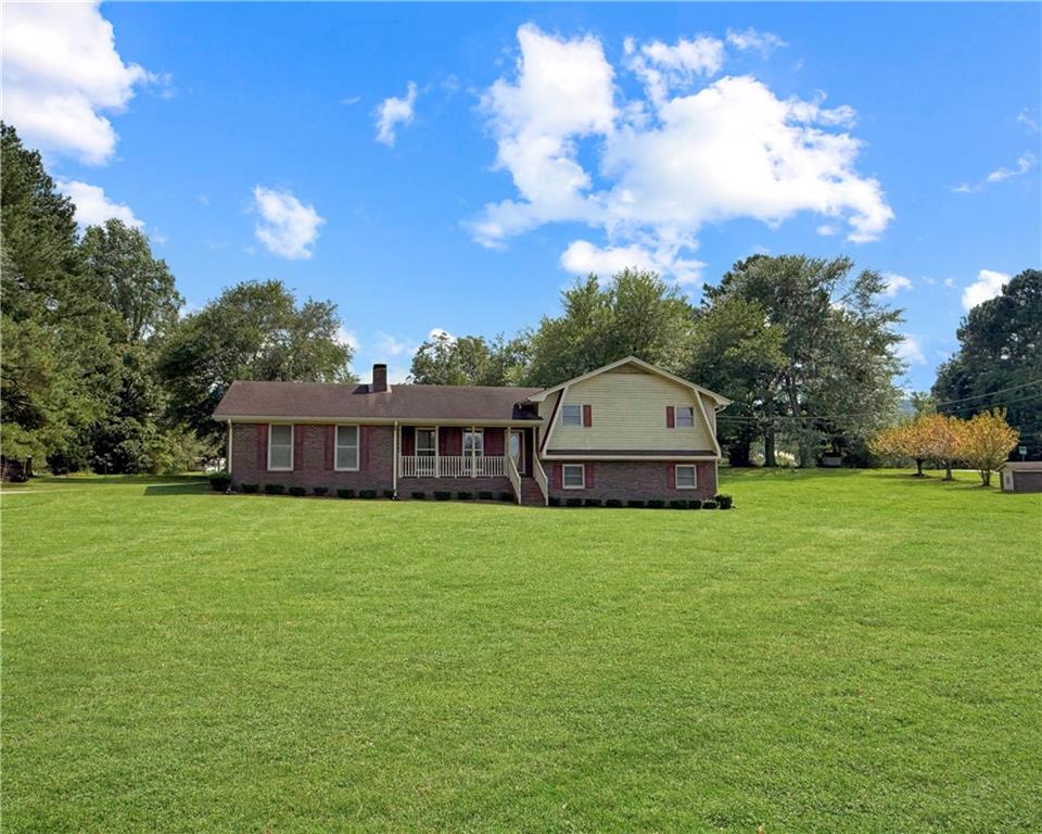 Charming split-level home with In-law suite and abundant outdoor space! This home sits on 1.6 acres in a highly sought after area with no HOA. Residence offers the perfect blend of comfort and functionality featuring a sunroom with natural light. At the heart of the home, you'll find the kitchen. This is designed for both convenience and style with updated cabinets and countertops along with stainless steel appliances and a layout that flows effortlessly into the family room. Adjoining family room provides a cozy space for relaxation and socializing with a beautiful stone fireplace. For bedrooms and baths, you'll find 2 spacious bedrooms, both with walk-in closets. 2 full baths and double vanity with attached closet for storage. Finished basement is a true highlight, boasting an In-Law Suite with kitchen, breakfast area, living room, full bath, and an area for bedroom. There is also a private entrance making it ideal for extended family living or guest accommodations. Property also features ample storage with additional buildings and a well-designed workshop right off of the garage area.