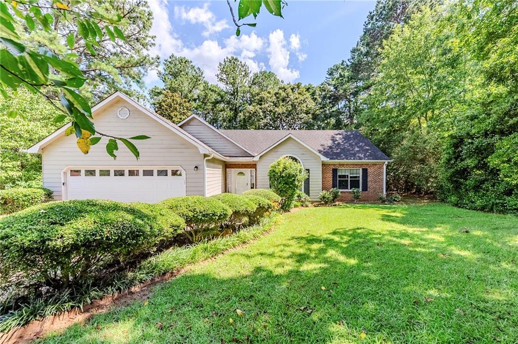 Welcome to this charming 3-bedroom, 2-bath ranch-style home located in the established Panhandle Plantation community. Featuring a freshly painted interior, the home offers a spacious great room with a brick fireplace, a functional kitchen with stained cabinets and laminate countertops, and a cozy dining area. The primary suite includes a separate tub and shower along with a walk-in closet. Enjoy outdoor living on the oversized deck or relax in the screened-in porch—perfect for morning coffee or evening unwinding. This property sits on a private, half-acre lot with mature trees and plenty of outdoor space. Ideal for those seeking a comfortable, one-level layout in a quiet neighborhood near local shopping, schools, and main commuter routes. Schedule a showing today! One or more photos have been virtually staged.